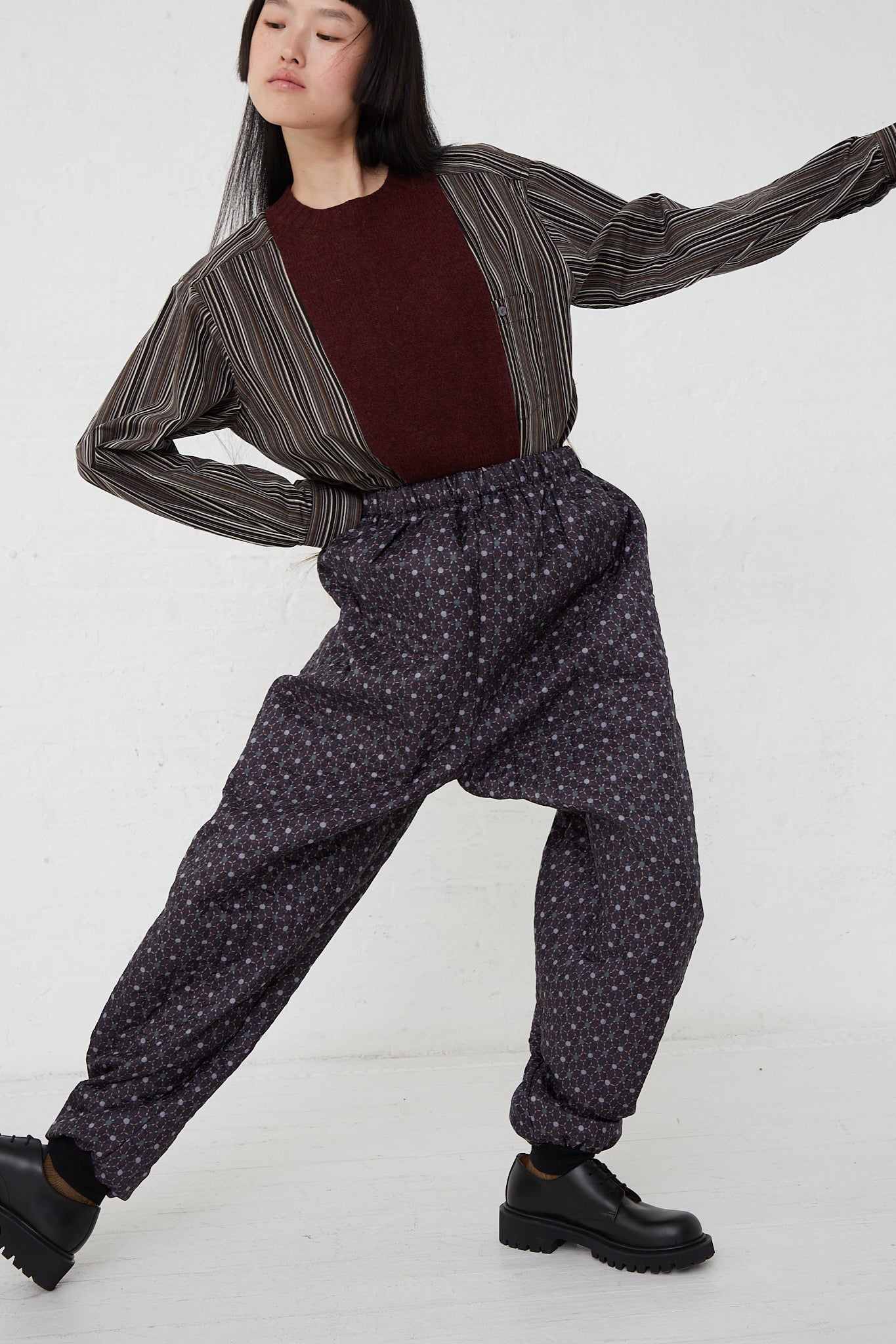 A woman wearing Monpe Pant No. 08 in Floral Print A - L by Bless and a stripe sweater.