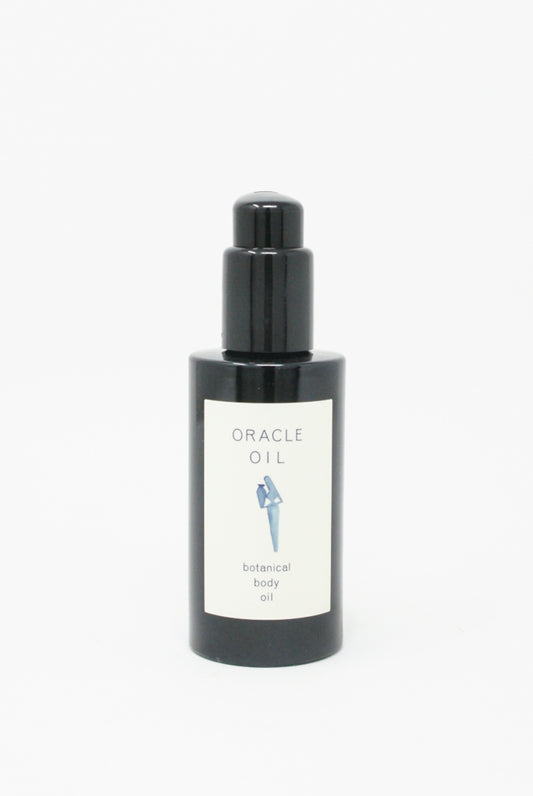 A bottle of Oracle Oil Botanical Body Oil, infused with Mediterranean botanicals, on a white background.