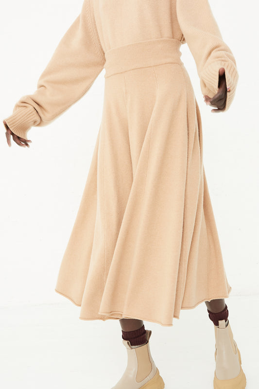 A model wearing No. 313 Twirl Skirt in Camel by Extreme Cashmere