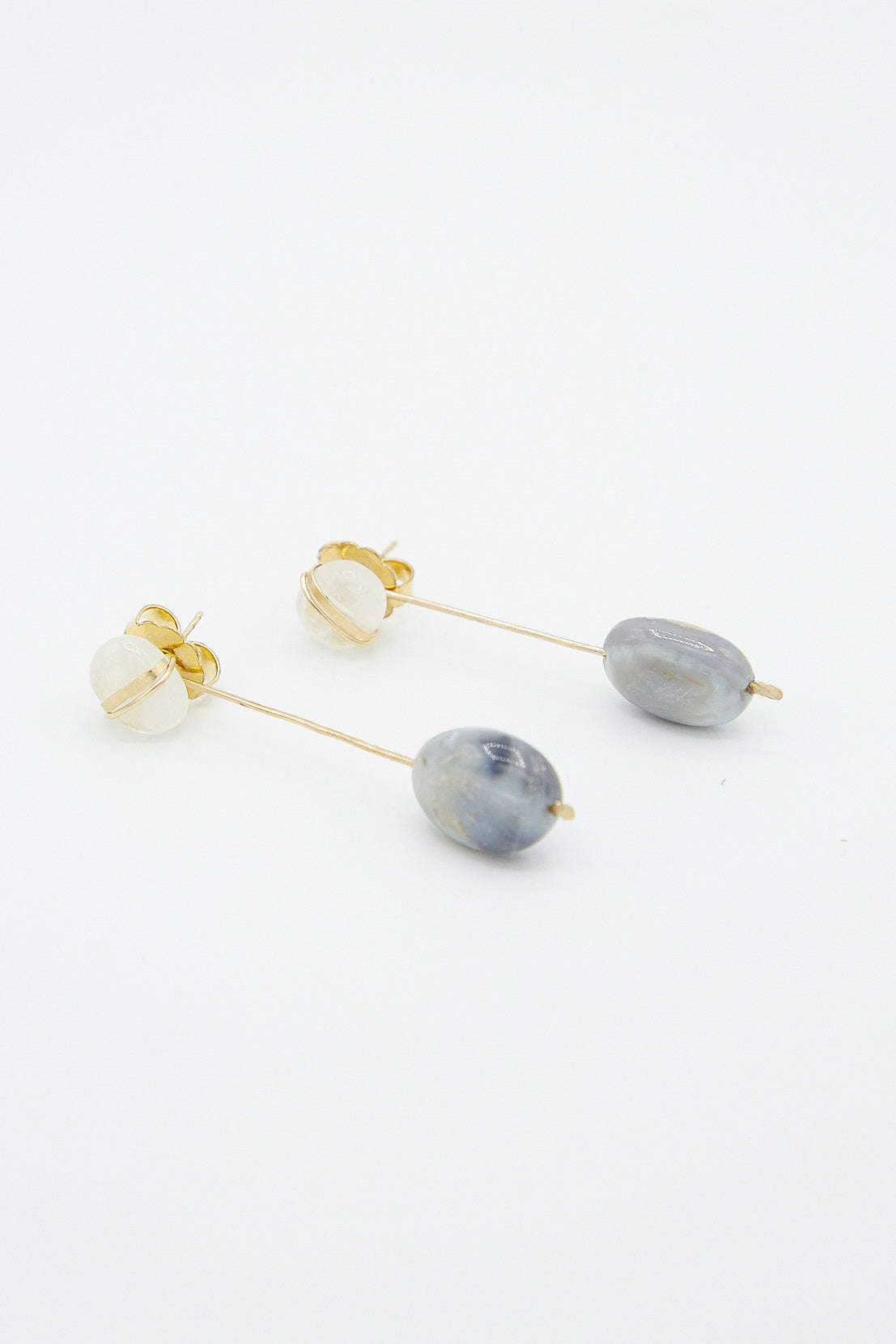 A pair of Mary MacGill Sculpture Earrings in Cottonwood II with blue and white stones.