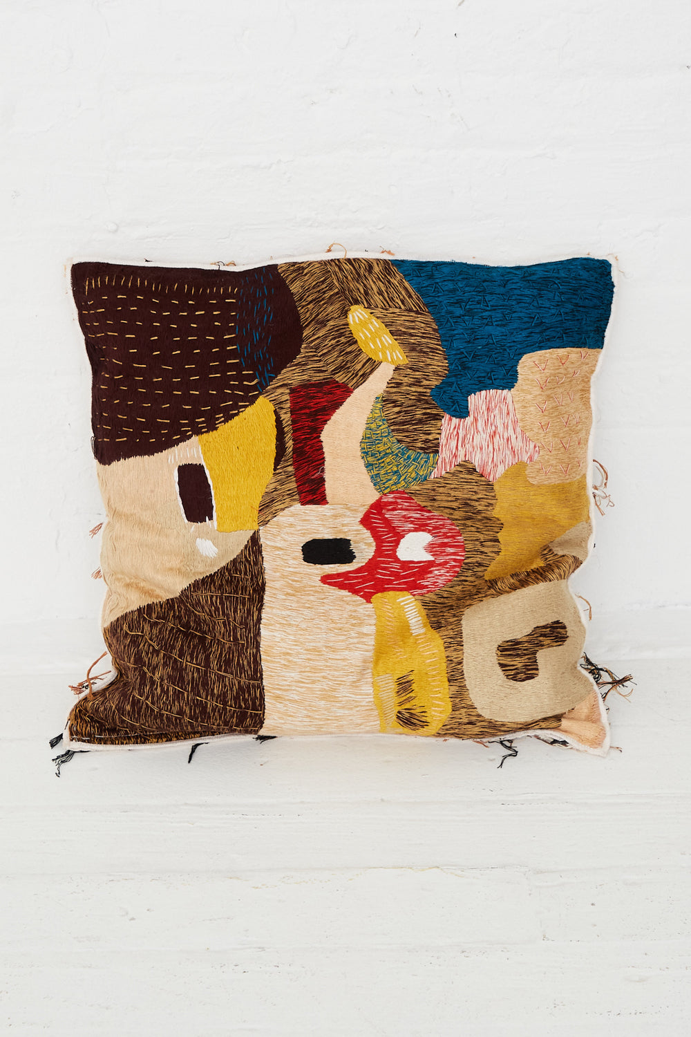 A Complex Embroidery Cave Cushion with a colorful pattern and hand embroidery by Luna Del Pinal.