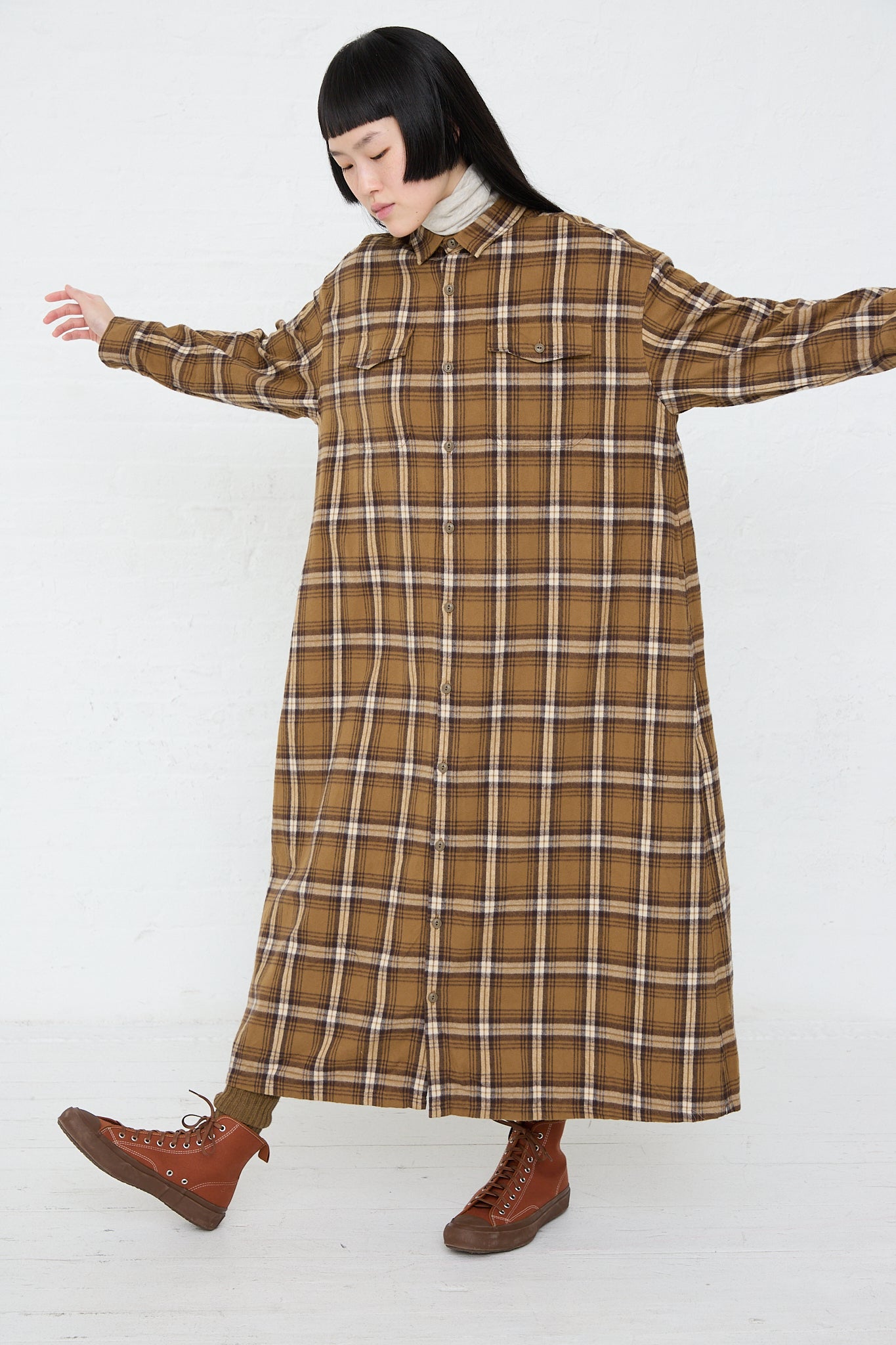 A woman in an Ichi Woven Cotton Dress in Camel. Full length.