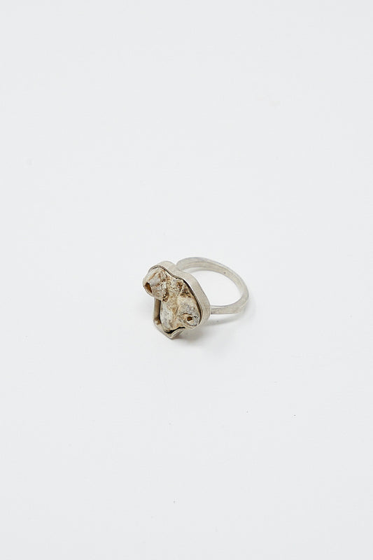 A La Ma r sterling silver ring with a diamond in the middle.
