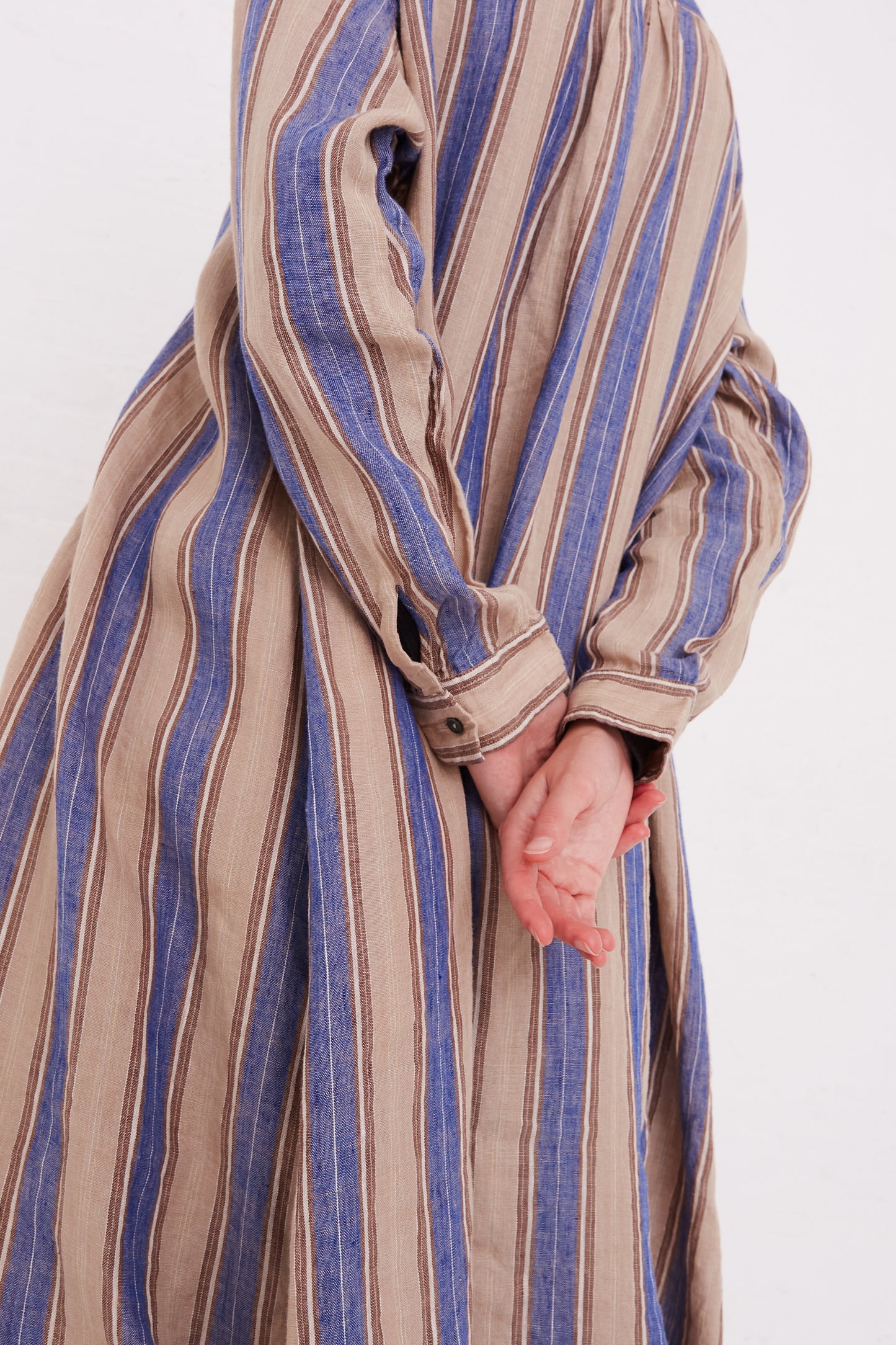 A woman wearing a Linen Stripe Dress in Blue by Ichi Antiquités.