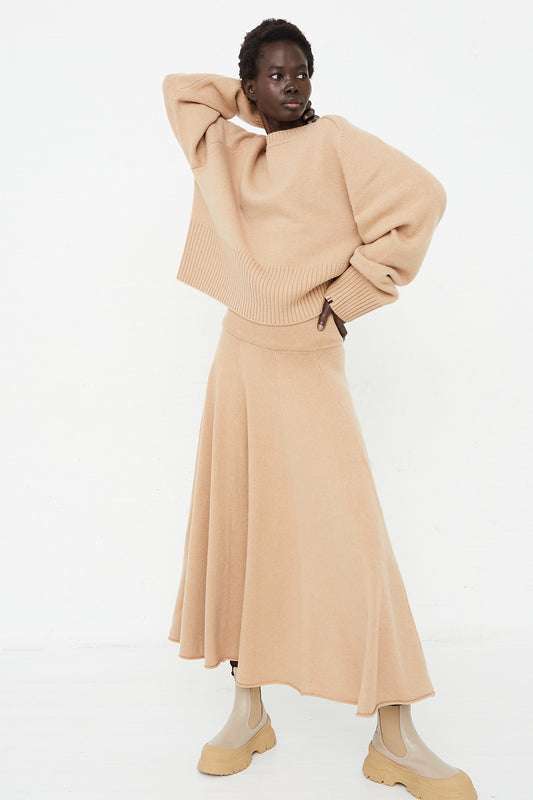 A model wearing No. 313 Twirl Skirt in Camel front view full length by Extreme Cashmere