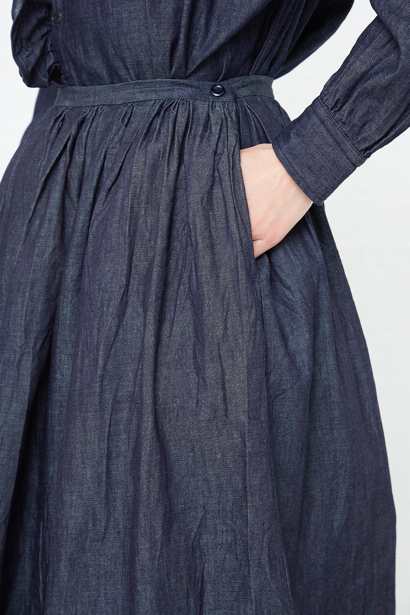 An organic Cotton Denim Cloth Pleated Maxi Skirt in Indigo by Toujours. Available at Oroboro Store.