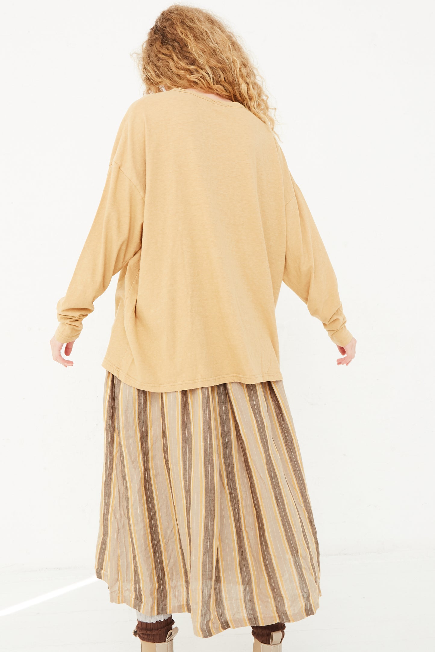 The back of a model wearing an Ichi Antiquités Cotton Loose Pullover in Camel, long sleeve top.