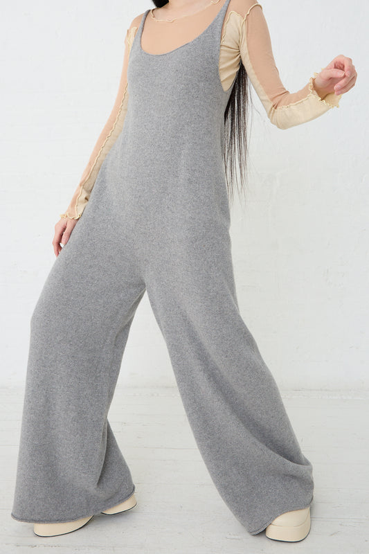 The model is wearing a Baserange Recycled Cashmere Rim Tank Jumpsuit in Grey Melange. Front view.