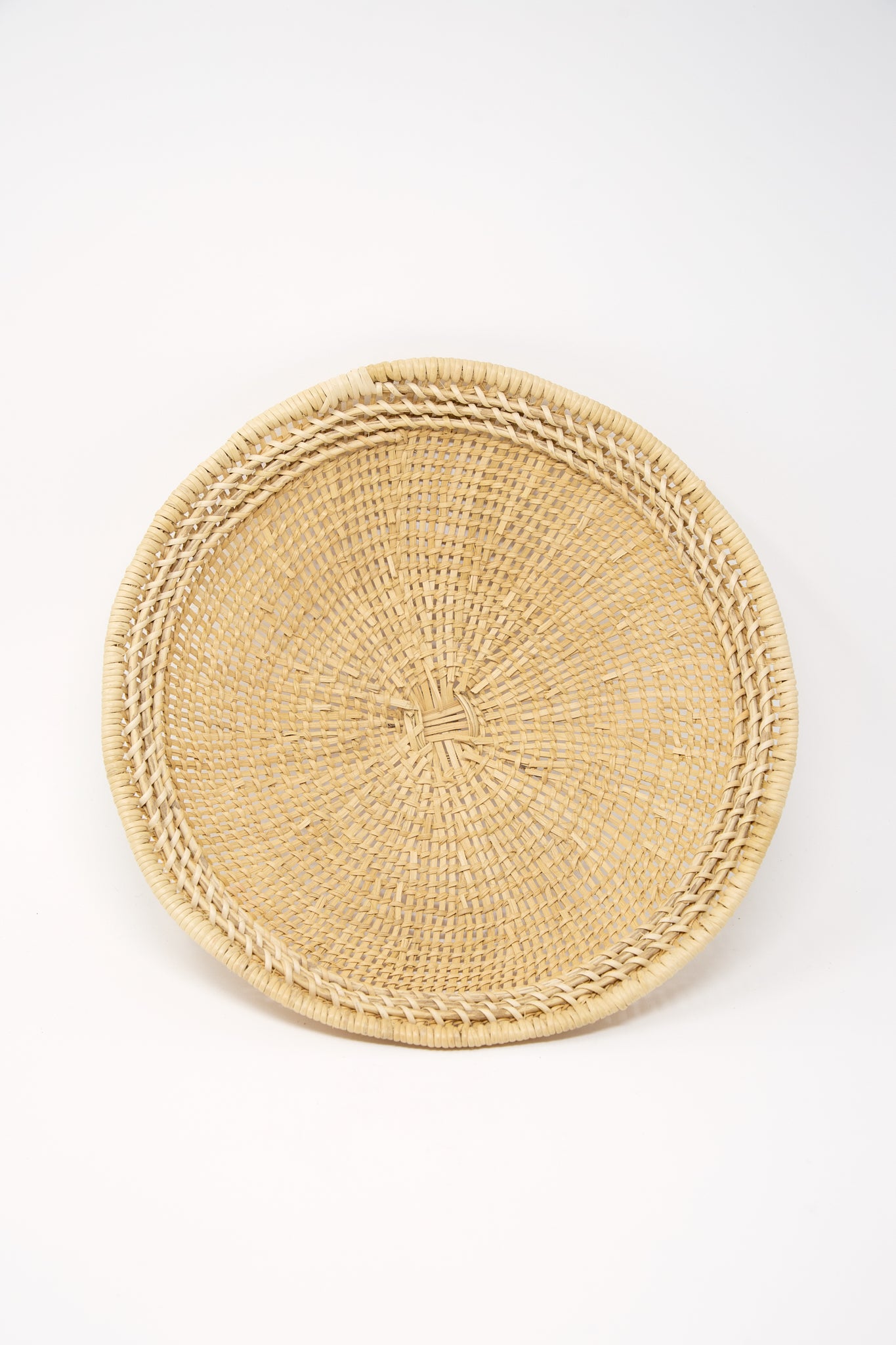 A Small Avia Pova Basket, handcrafted by an artisan, on a white background, produced by Plaza Bolivar.