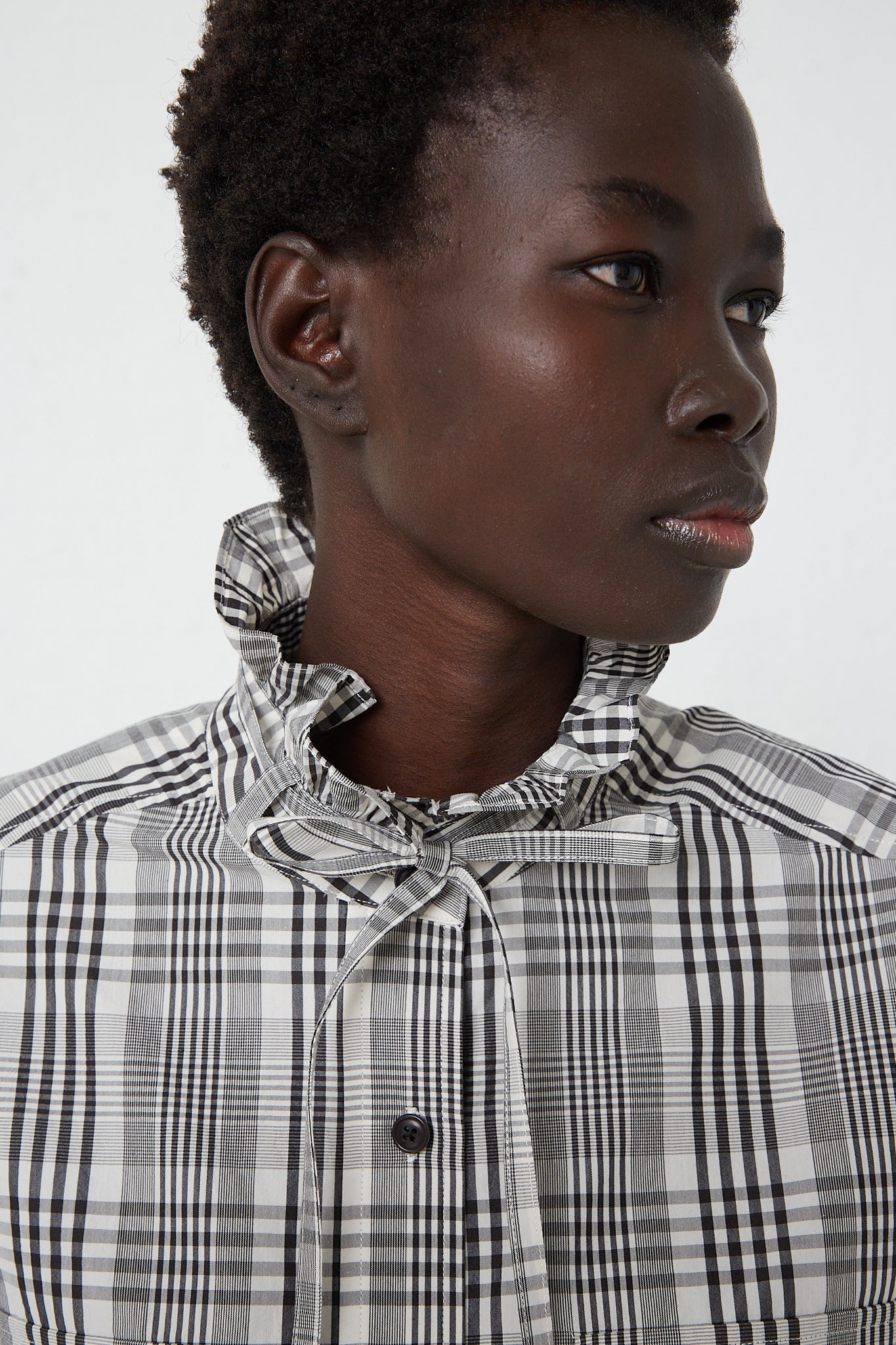 A KasMaria Poplin Tie Shirt with Ruffle Collar in Heavy Plaid. Up close view of collar.