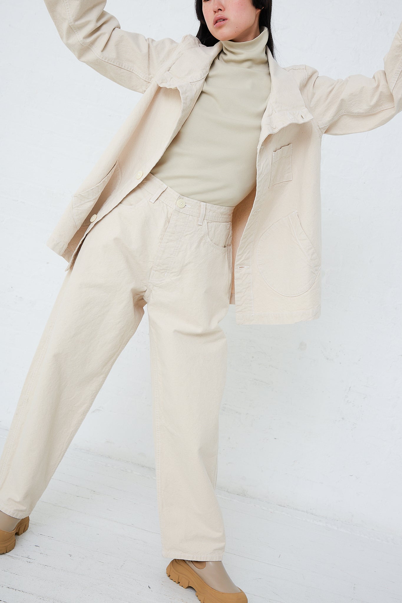 A woman in Jesse Kamm's Organic Canvas California Wide in Natural made of organic cotton canvas.