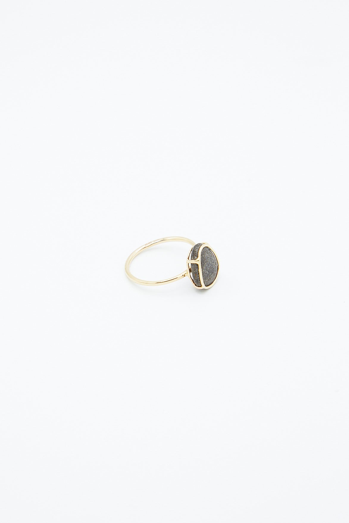A Mary MacGill 14k Floating Ring in Island Stone, handmade with a black stone, featuring a unique Block Island stone. Side view.