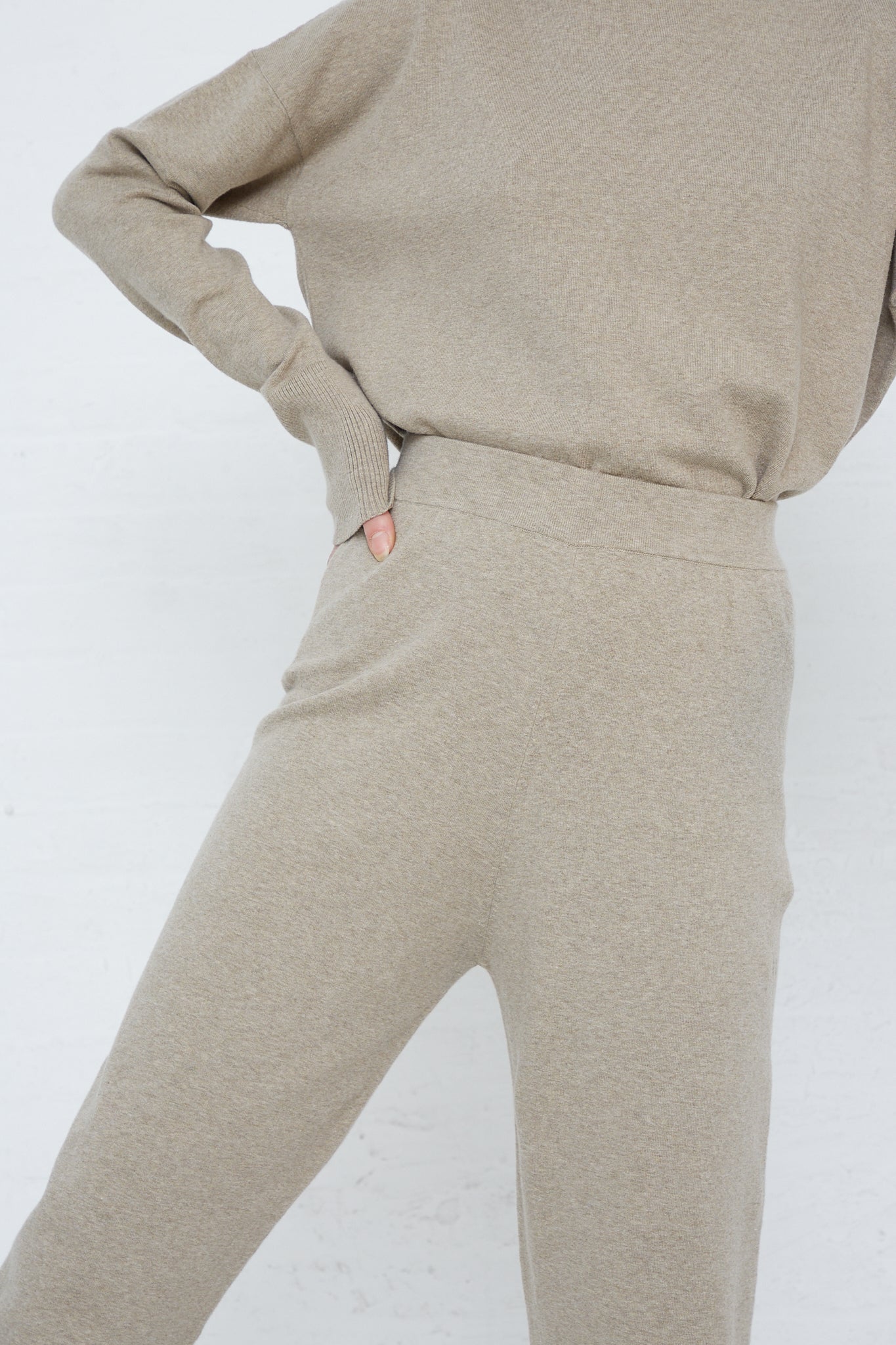 The model is wearing a beige sweater and the Lauren Manoogian Base Pant in Stone Melange with an elasticated waist. Front view and up close.