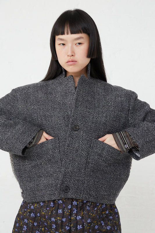 The model is wearing a Bless Work Jacket No. 75 in Greymix herringbone.