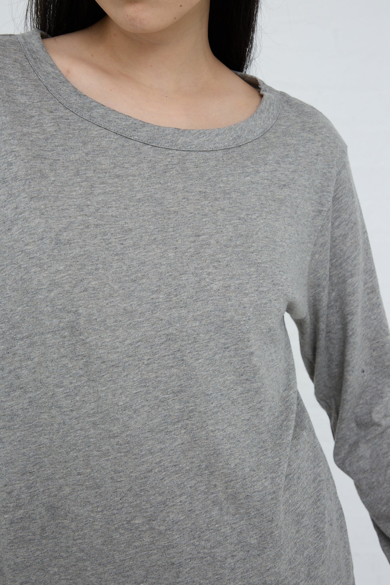 A woman wearing a relaxed fit, gray long-sleeved Ichi Cotton Knit Pullover. Front view and up close.