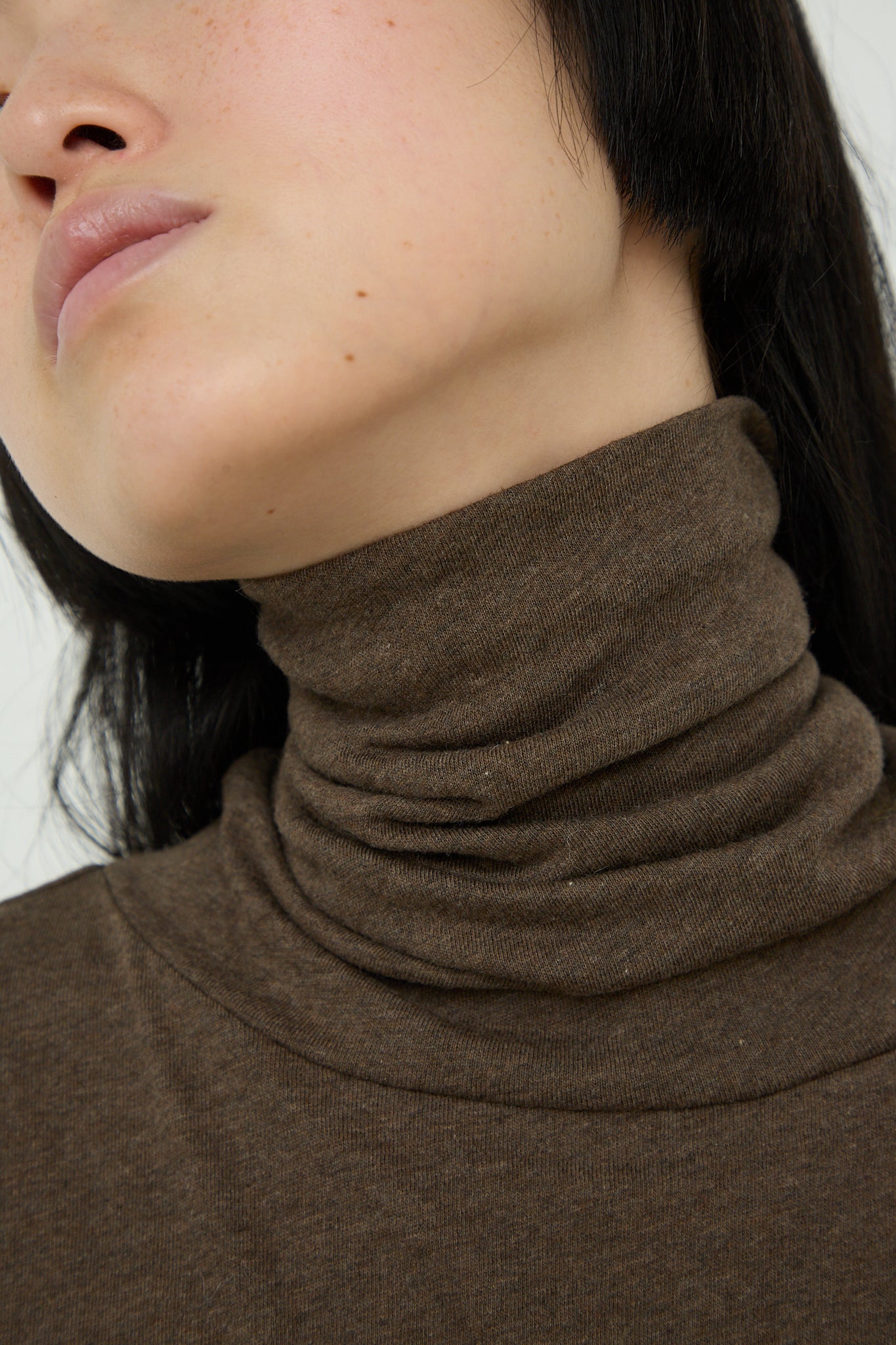 A woman wearing an Ichi Cotton Knit Turtleneck in Mocha. Up close view of neck.