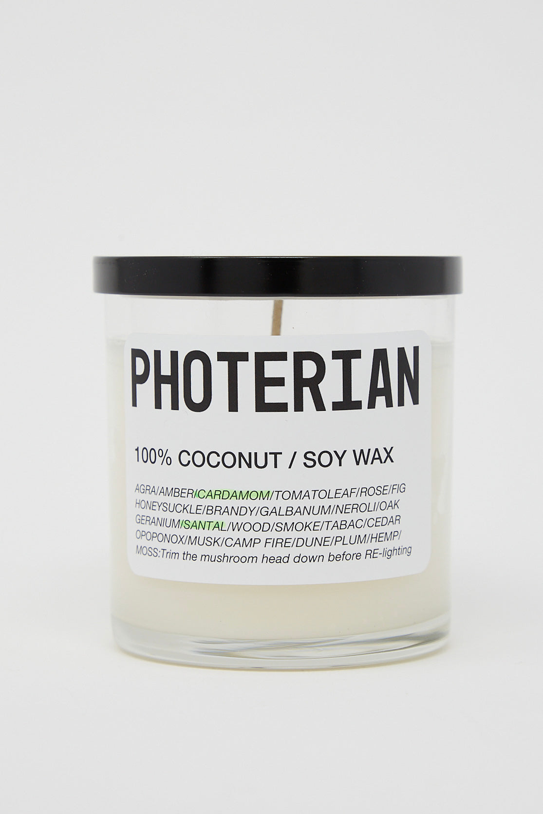A Votive Coconut Soy Candle in Santal Cardamom with the brand name Photerian on it.