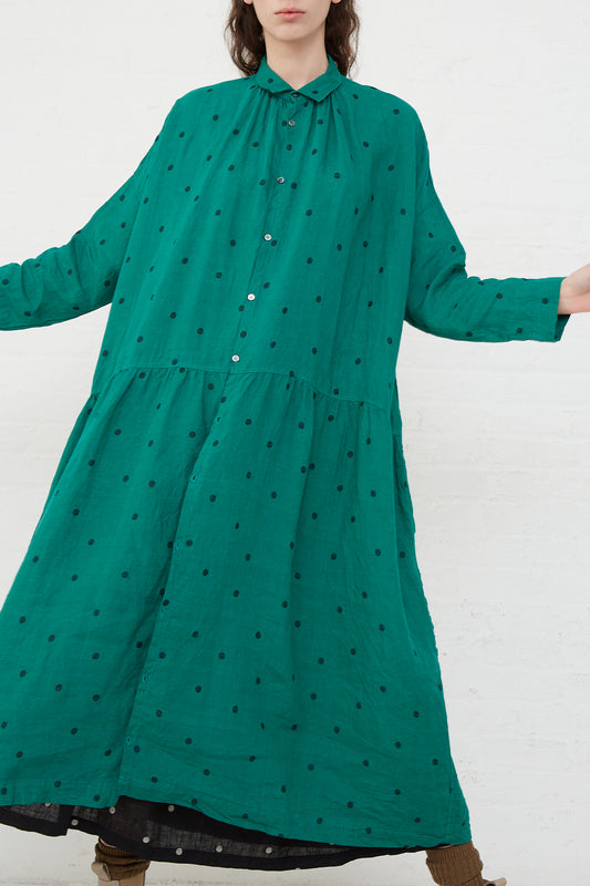 The model is wearing an Ichi Antiquités Linen Dot Dress in Green and Black with gathers at waist.