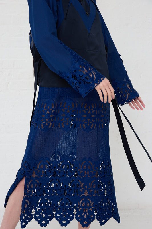 A woman wearing a TOGA PULLA Mesh Lace Dress in Blue.