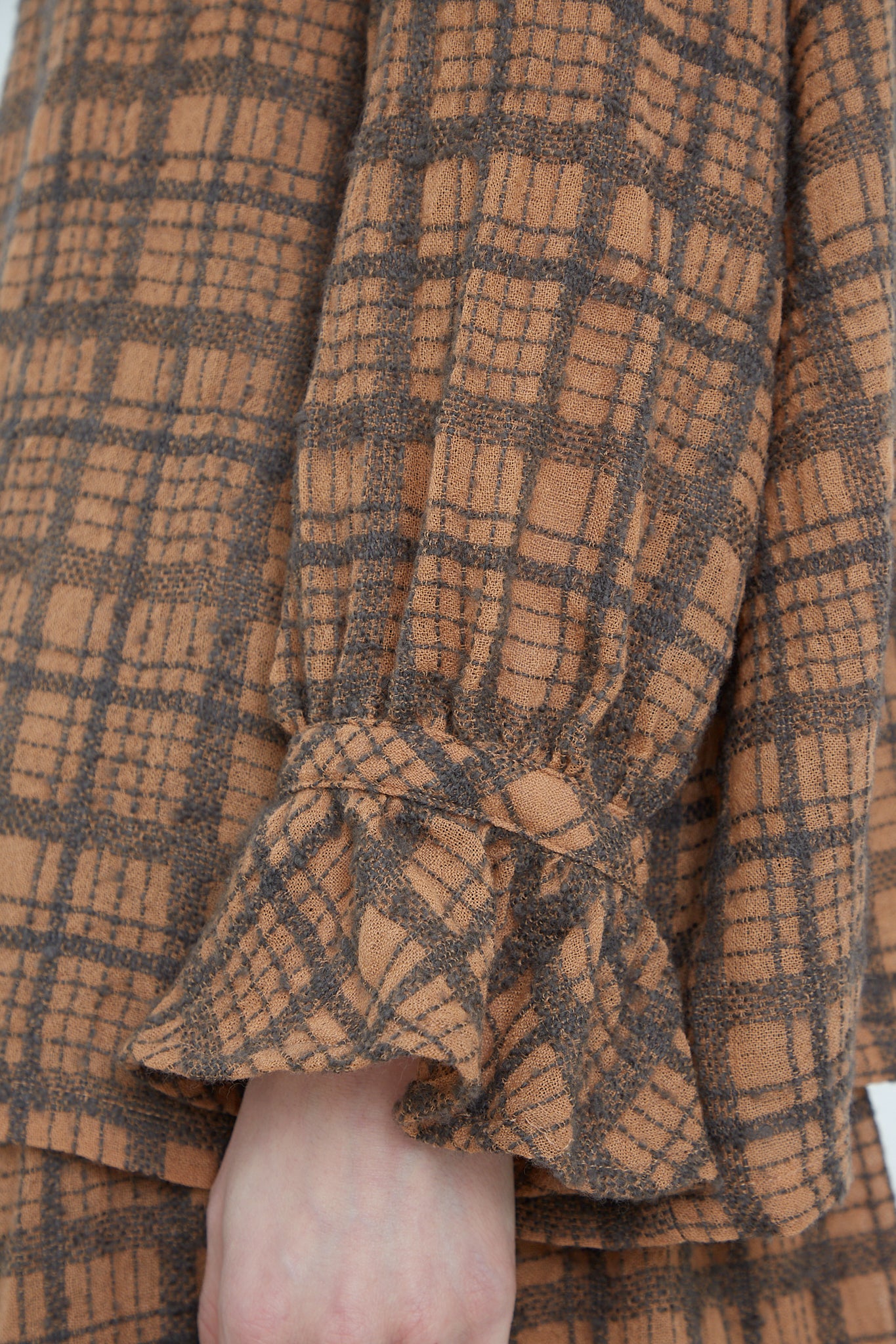 A close up of a woman wearing a Ichi Antiquités Wool Check Frill Blouse in Terracotta.