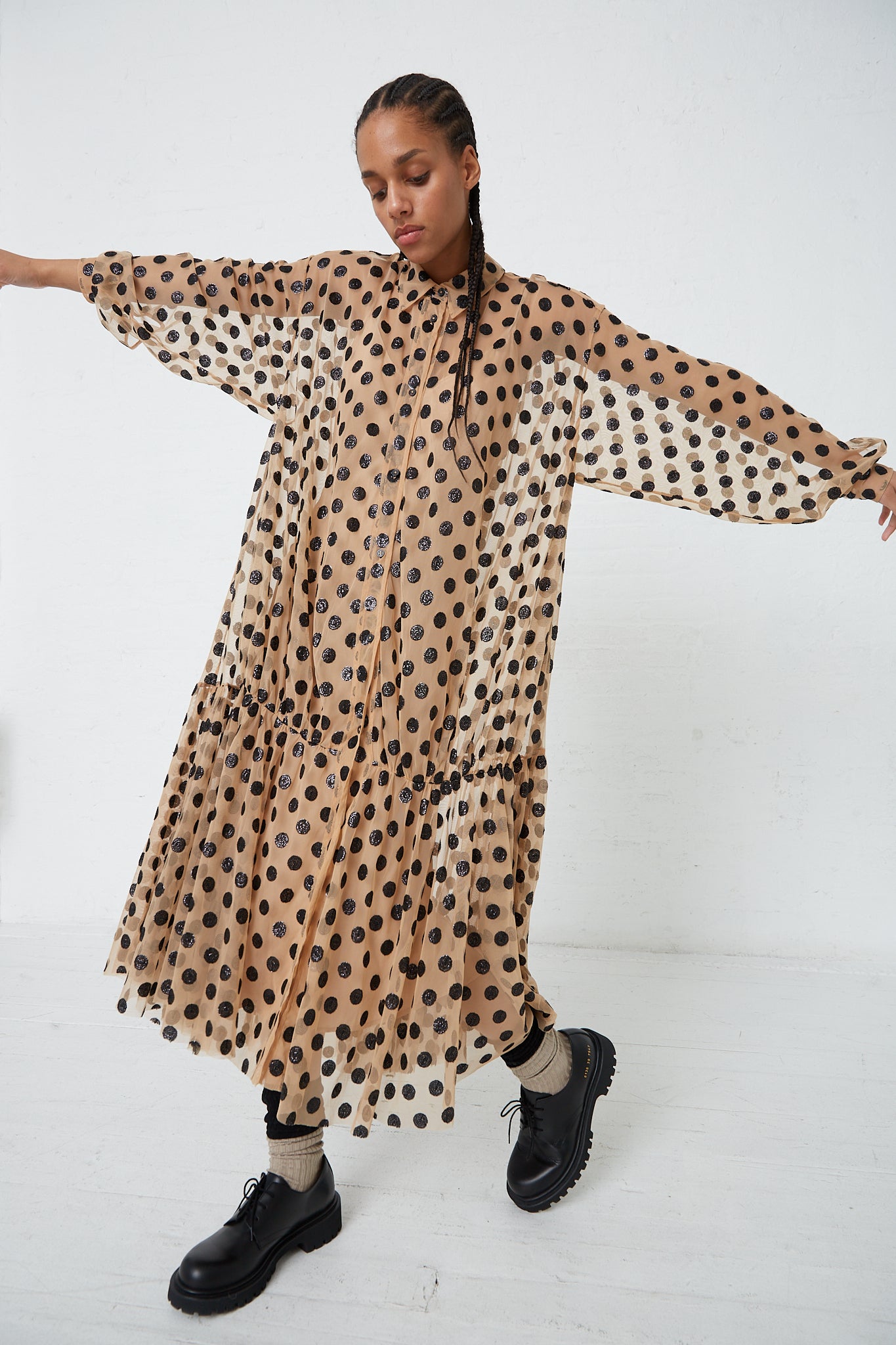 A woman in a Rachel Comey Sequin Dots Tulle Lanza Dress in Nude.