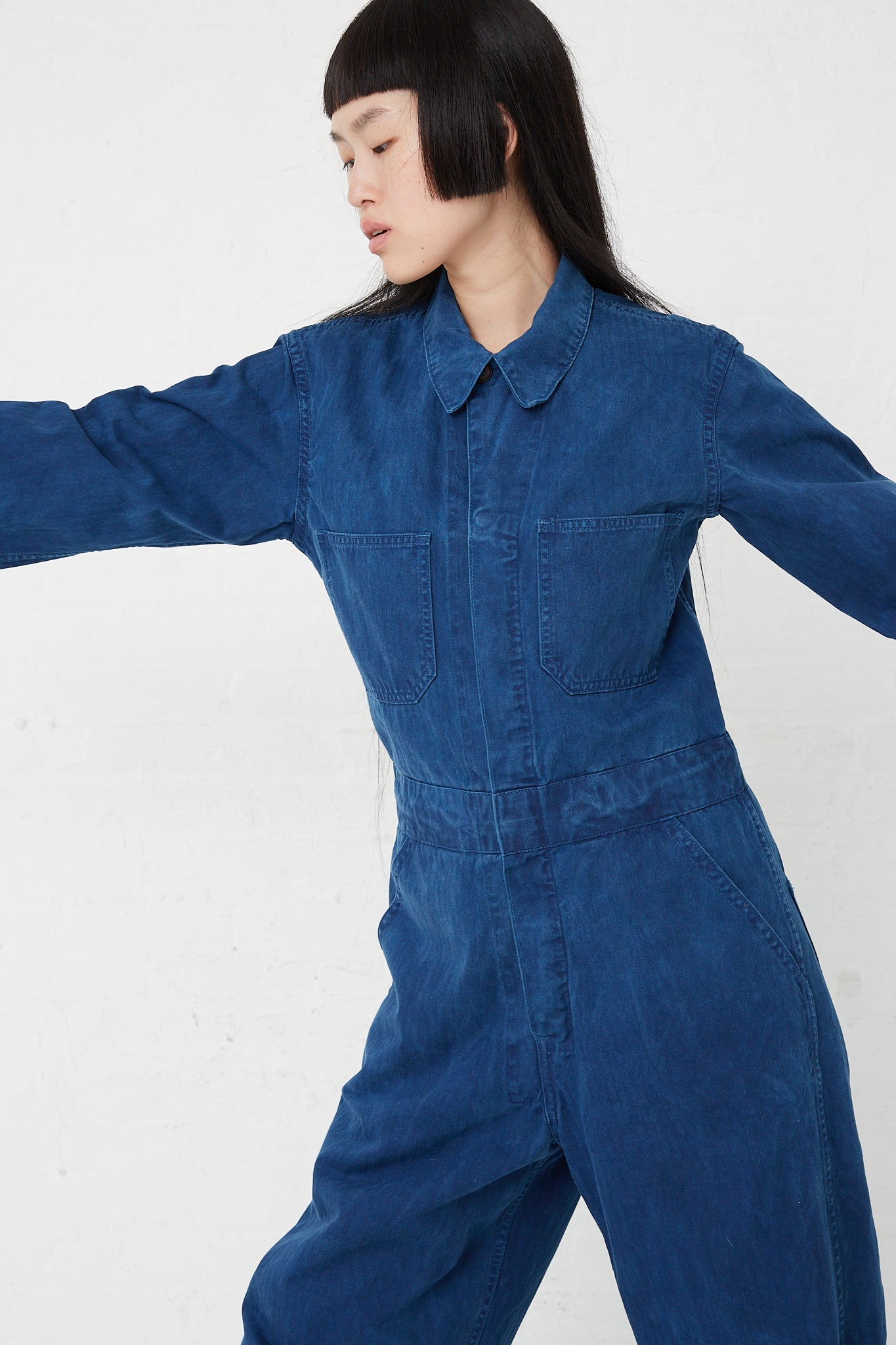 A woman in an As Ever hand-dyed Japanese twill Zip Jumpsuit in Indigo.