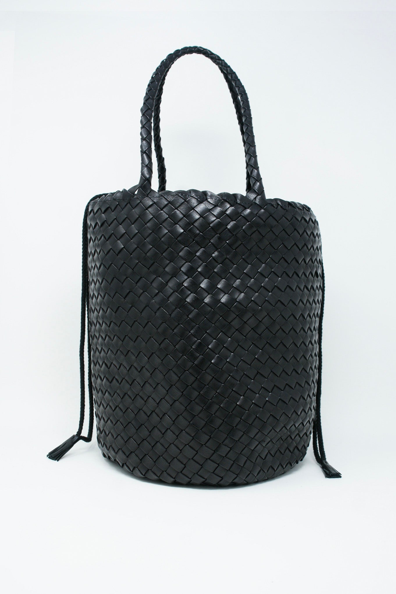 A black Dragon Diffusion Jacky Bucket Bag made with buffalo leather on a white background.