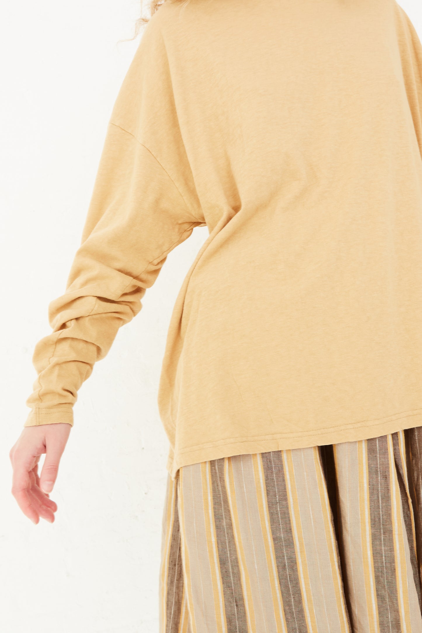 A model wearing a Cotton Loose Pullover in Camel by Ichi Antiquités, available at Oroboro store.