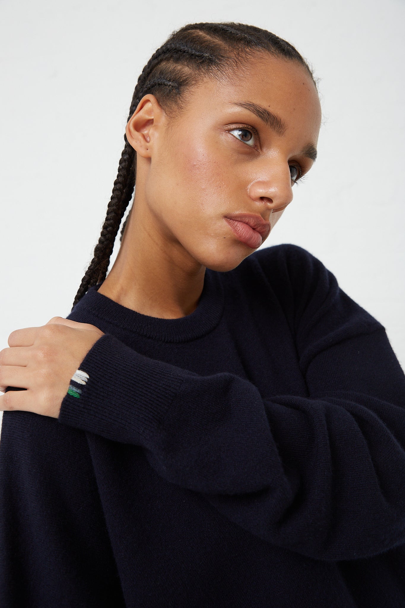 A woman wearing the Extreme Cashmere No. 106 Weird Dress in Navy, a relaxed fit navy sweater with a cashmere blend.