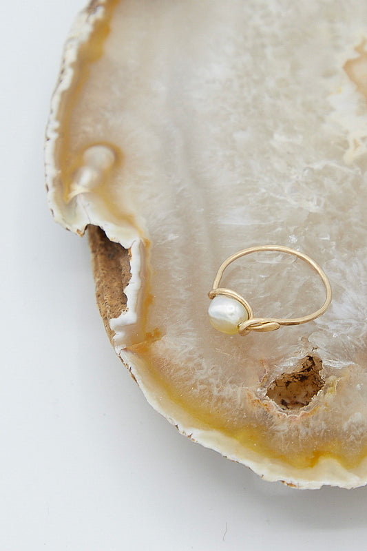 A Mary MacGill 14K Mermaid Ring in Golden Pearl with a pearl sitting on top of an agate.