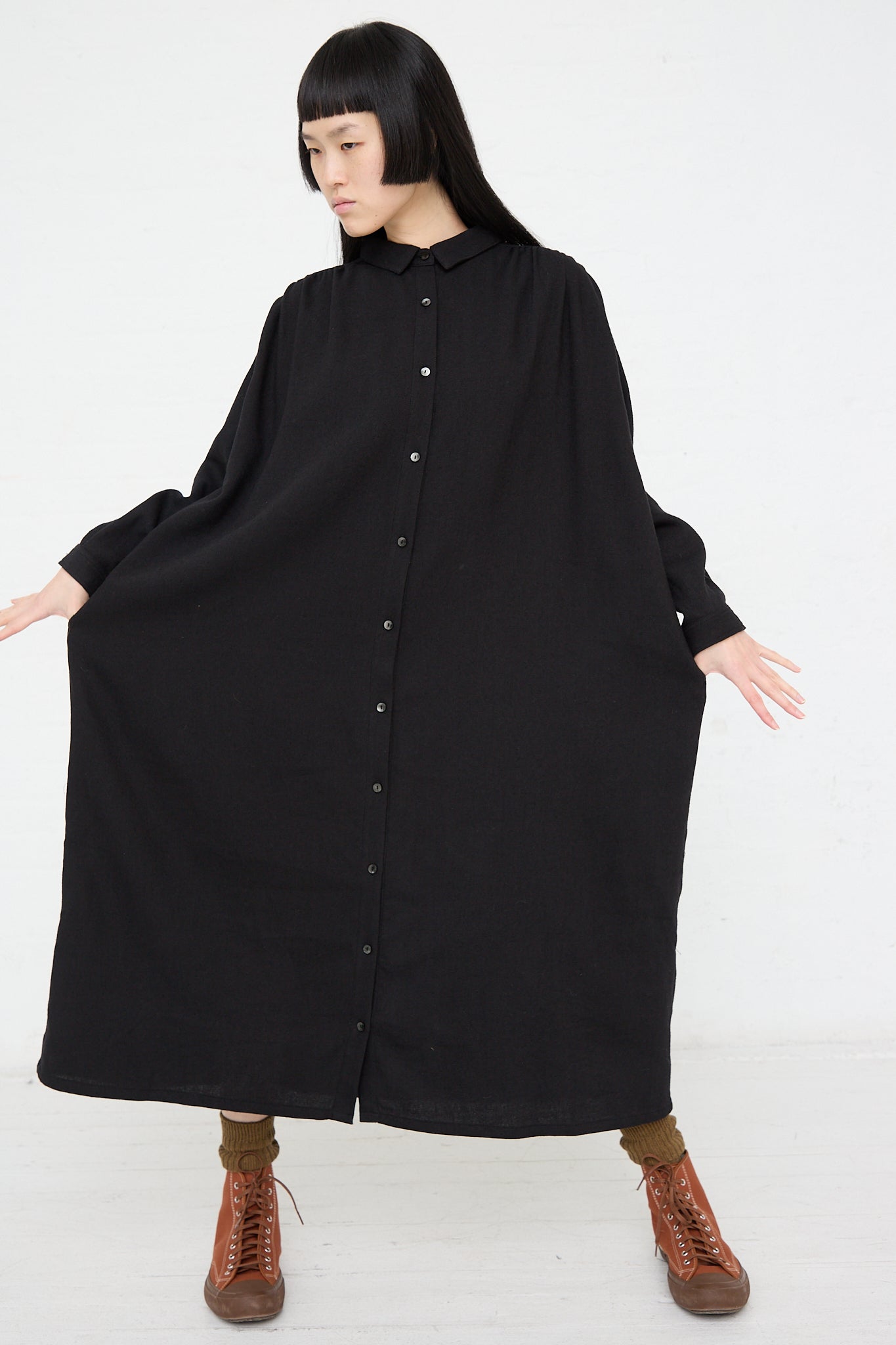 A woman wearing a long sleeve Ichi woven dress in black made of natural fibers.