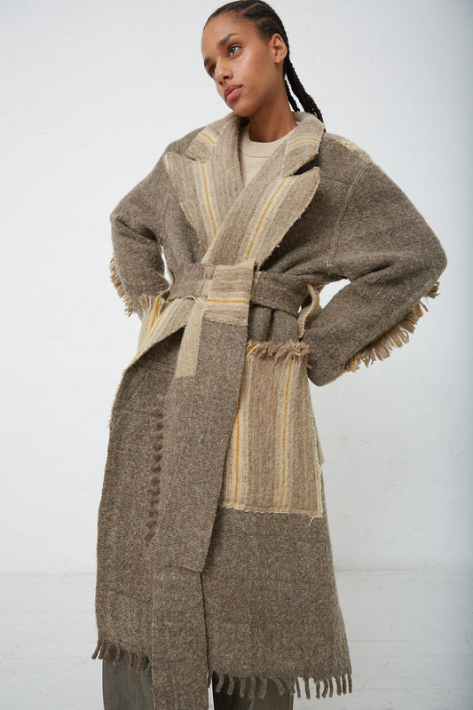 A woman wearing a Thank You Have A Good Day brown Wool Blanket Swing Trench with fringes.