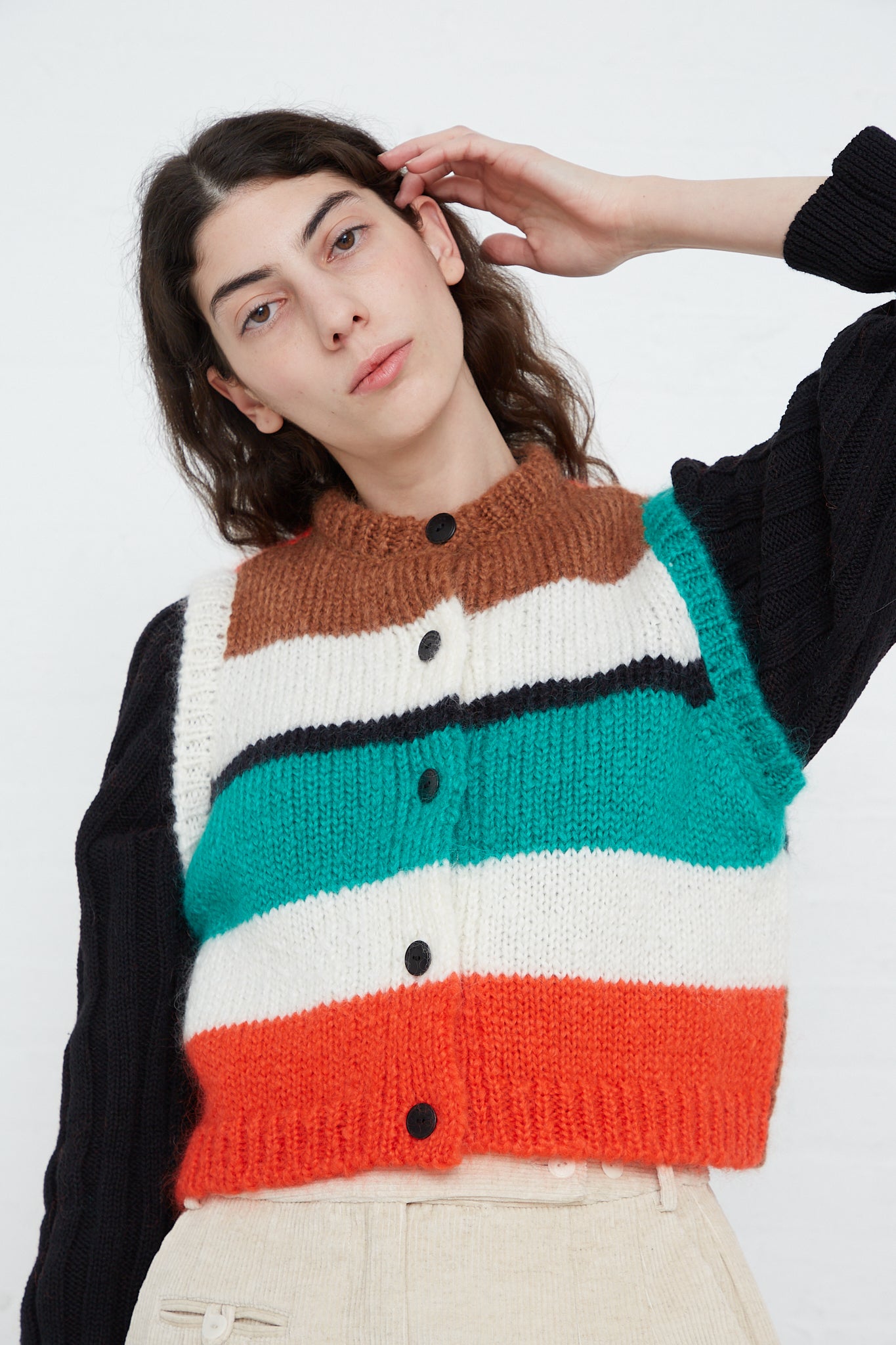 A model wearing a Cordera mohair waistcoat in striped with multicolored stripes.