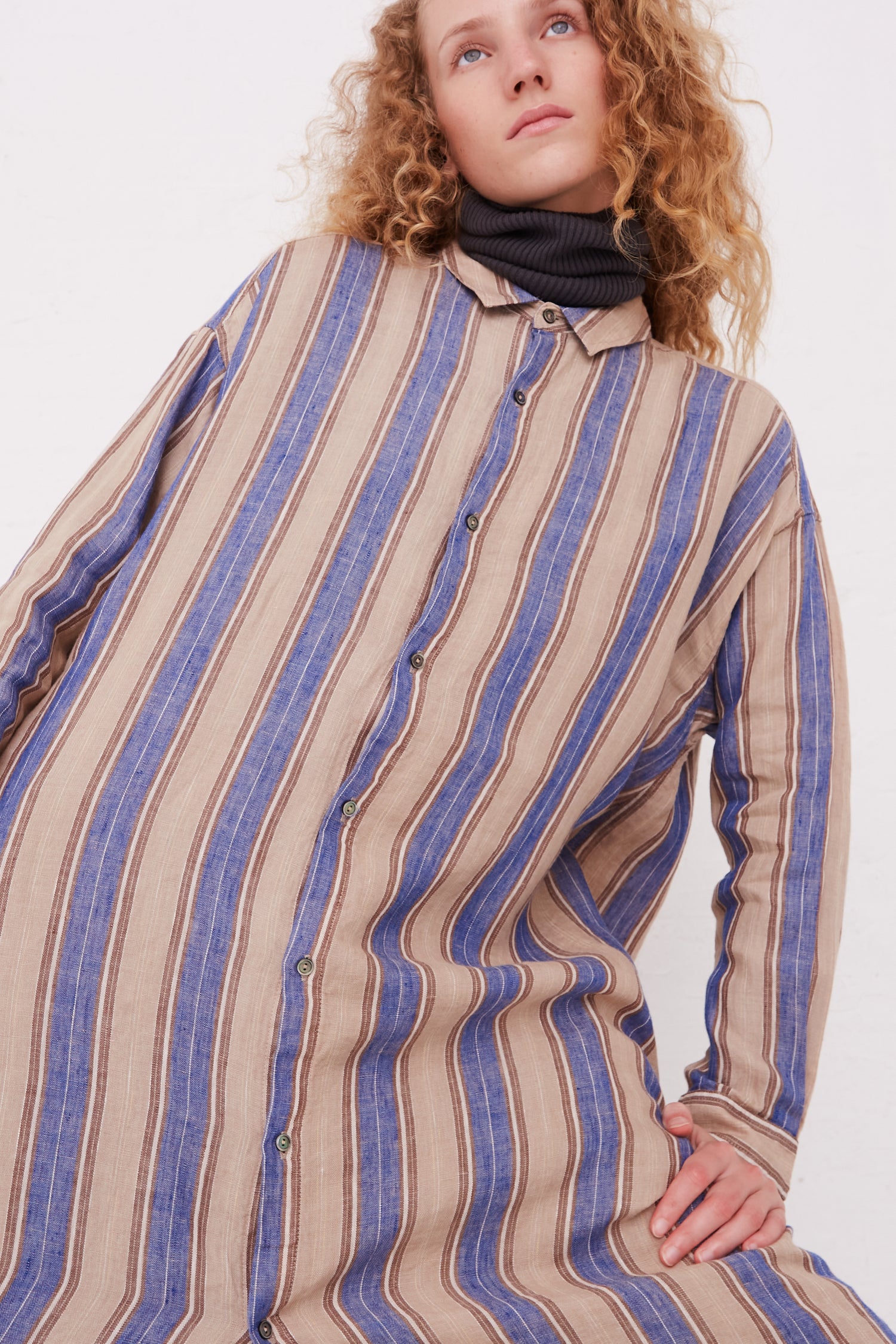 The model is wearing a long sleeve Ichi Antiquités Linen Stripe Dress in Blue.