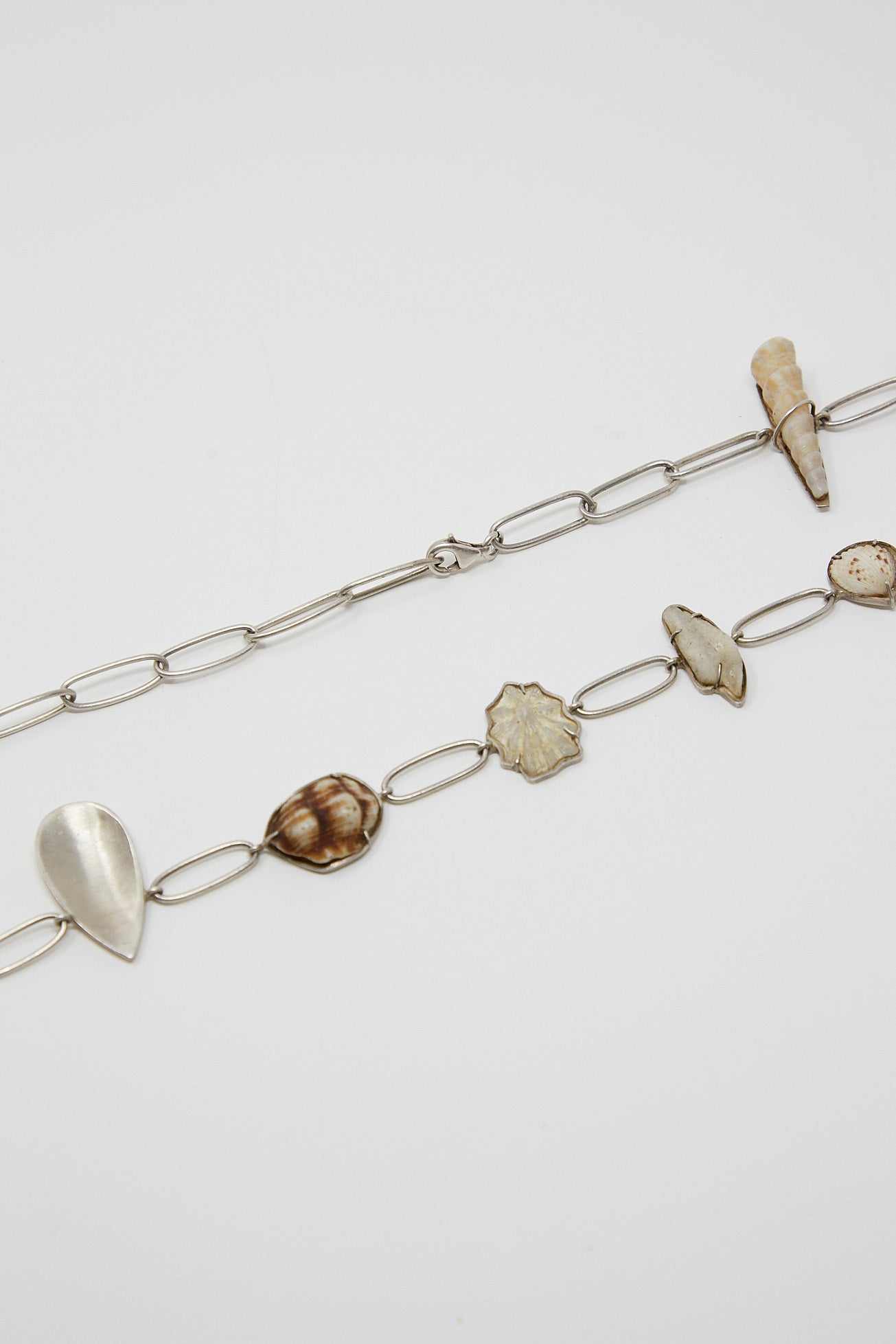 A unique La Ma r sterling silver shell belt adorned with an eclectic mix of stones and shells.