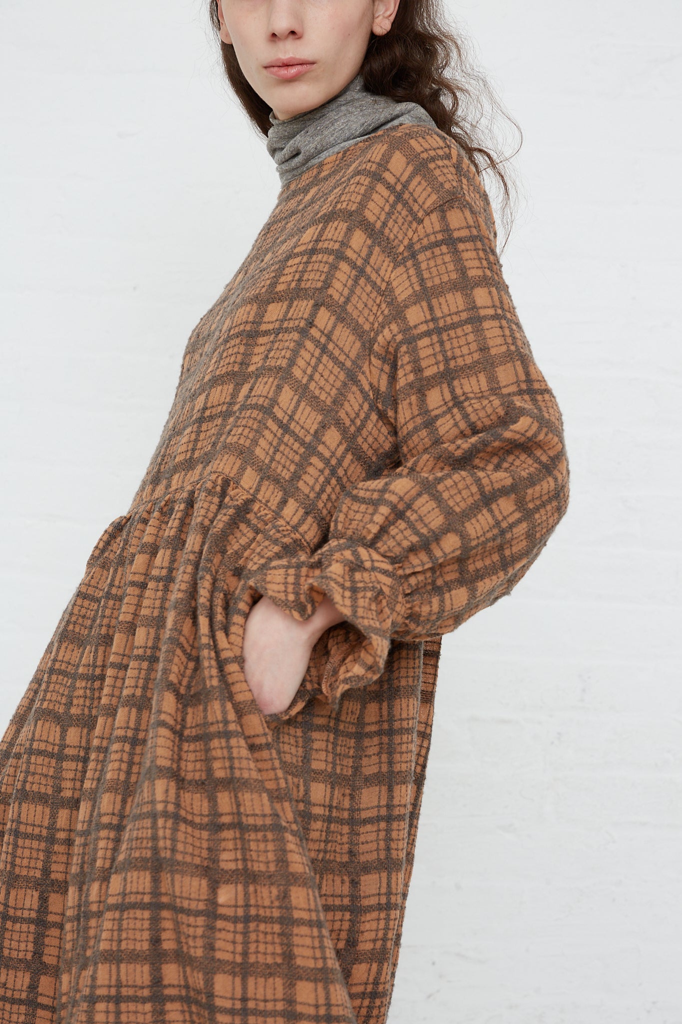 The model is wearing a Ichi Antiquités Woven Wool Check Dress in Terracotta.