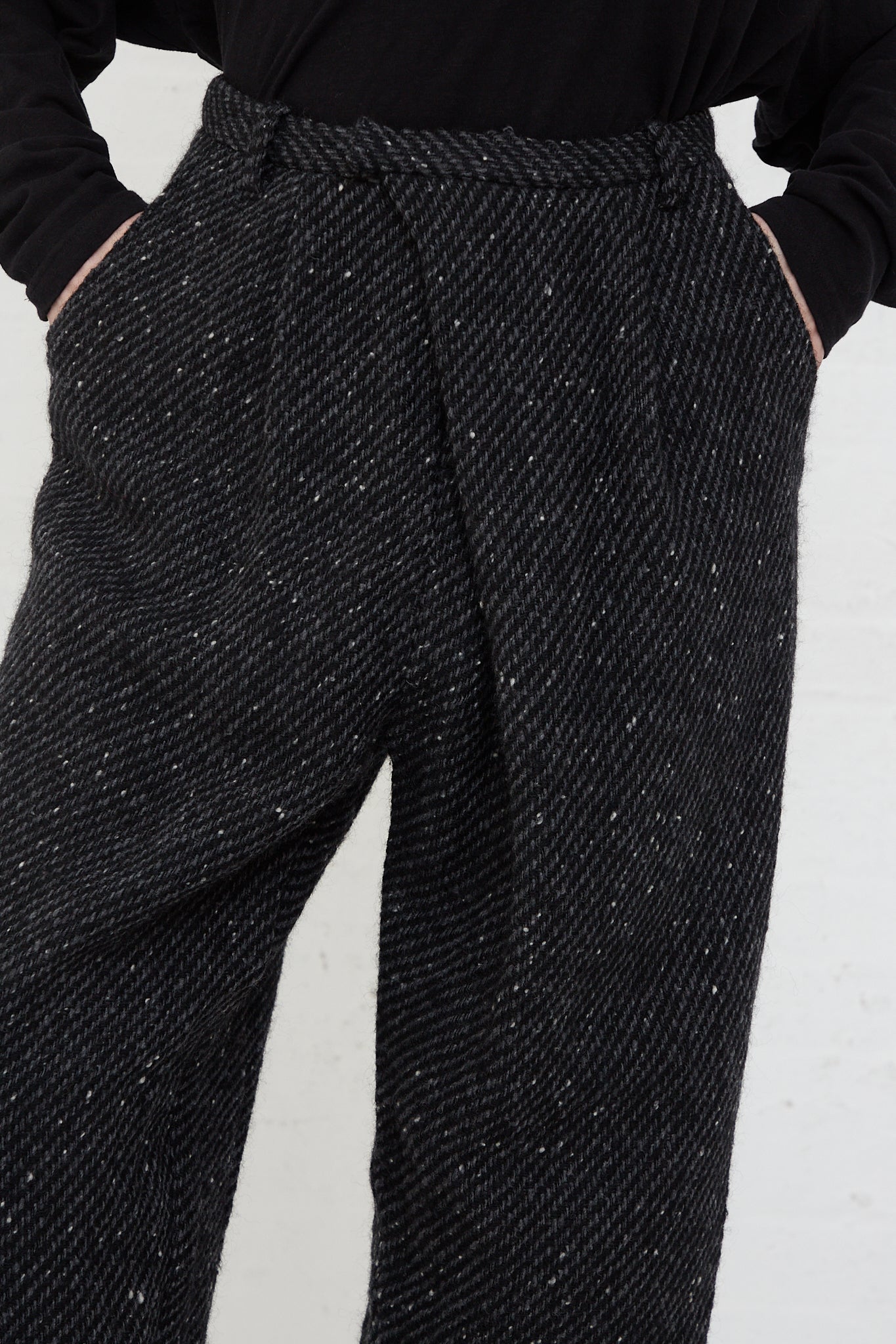A woman wearing Ichi Antiquités' Snow Nep Wool Pant in Black, and a black shirt.