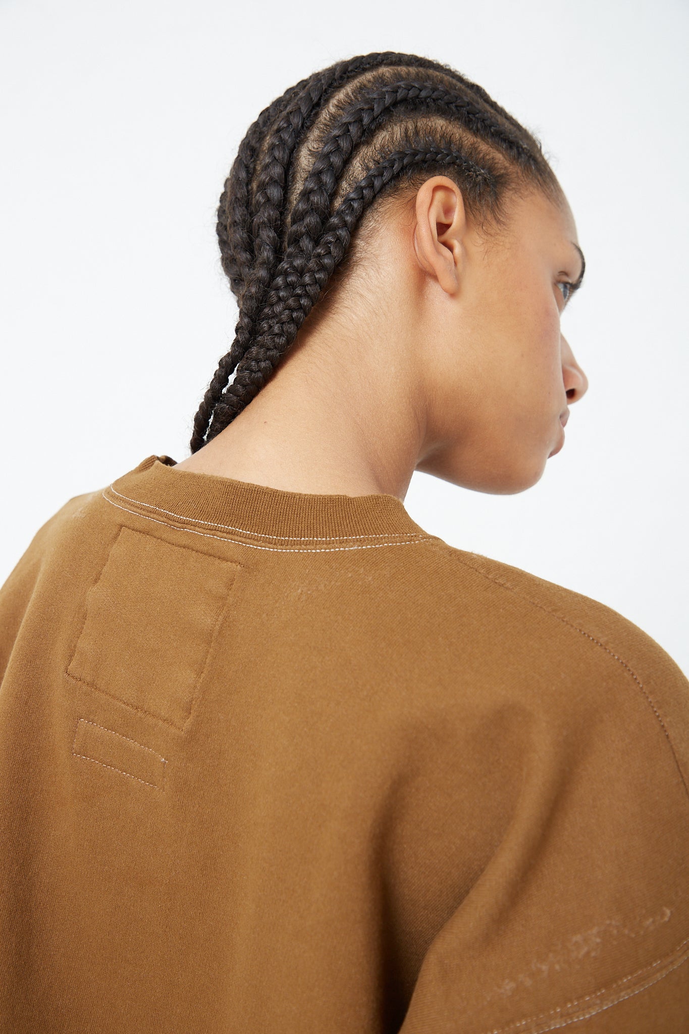 The back view of a woman wearing an oversized Rachel Comey Fond Sweatshirt in Umber. Up close.