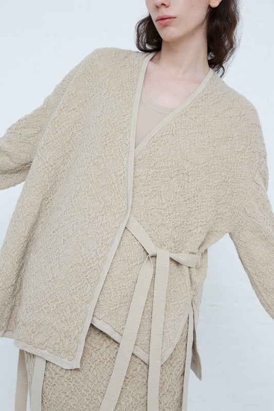A woman wearing a Lauren Manoogian Alpaca Gauze Cardigan in Antique made from knit alpaca. Front view. 