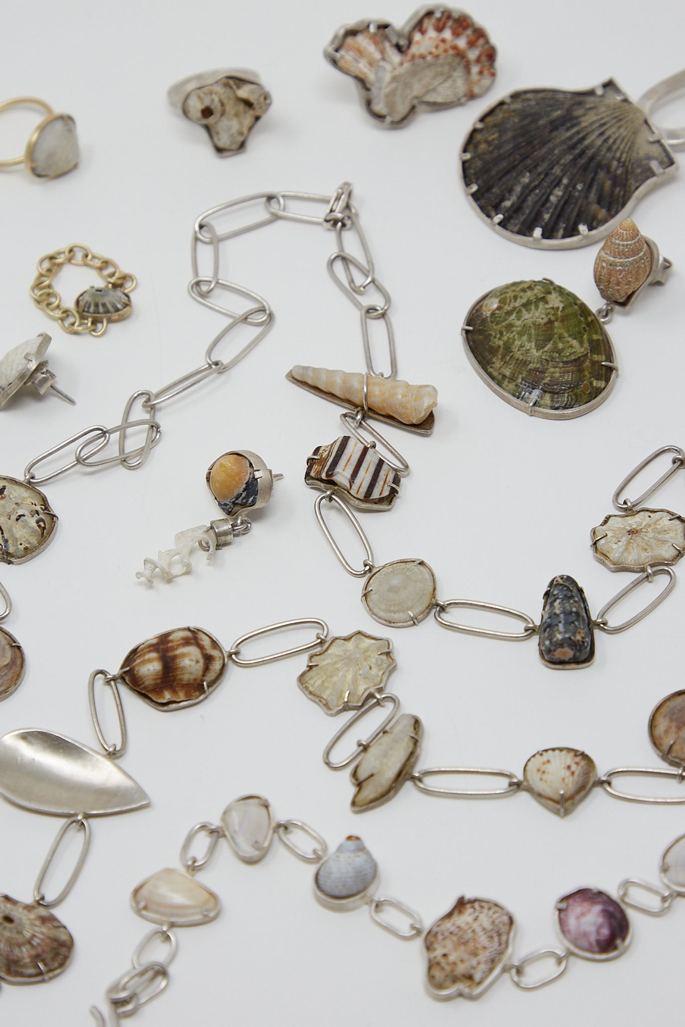 A collection of one-of-a-kind La Ma r jewelry, crafted with the Sterling Silver Bracelet 001 A and found shells.