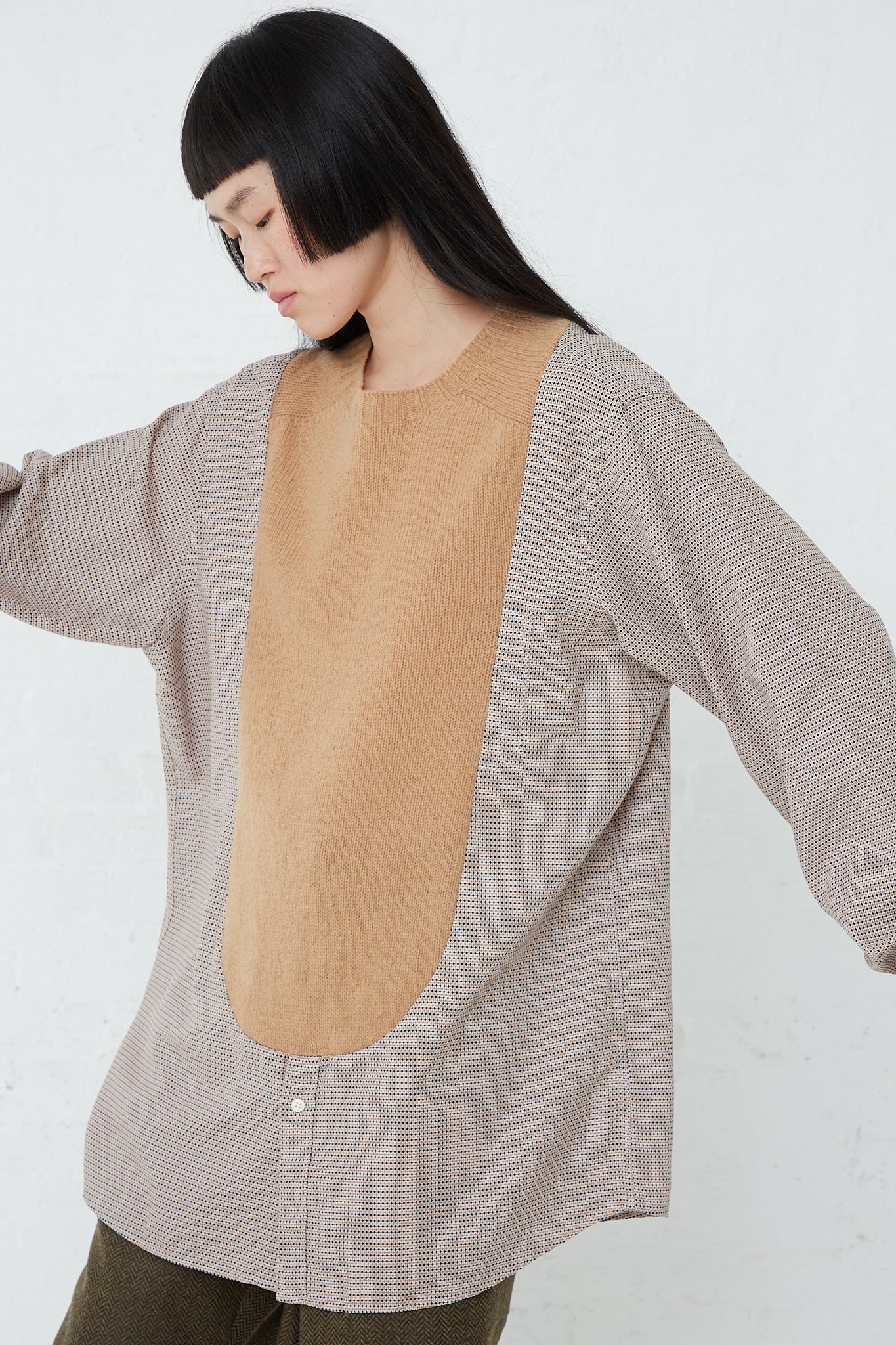 A woman wearing a Bless No. 68 Front Insert Pullover in Beige Pattern with a tan front.