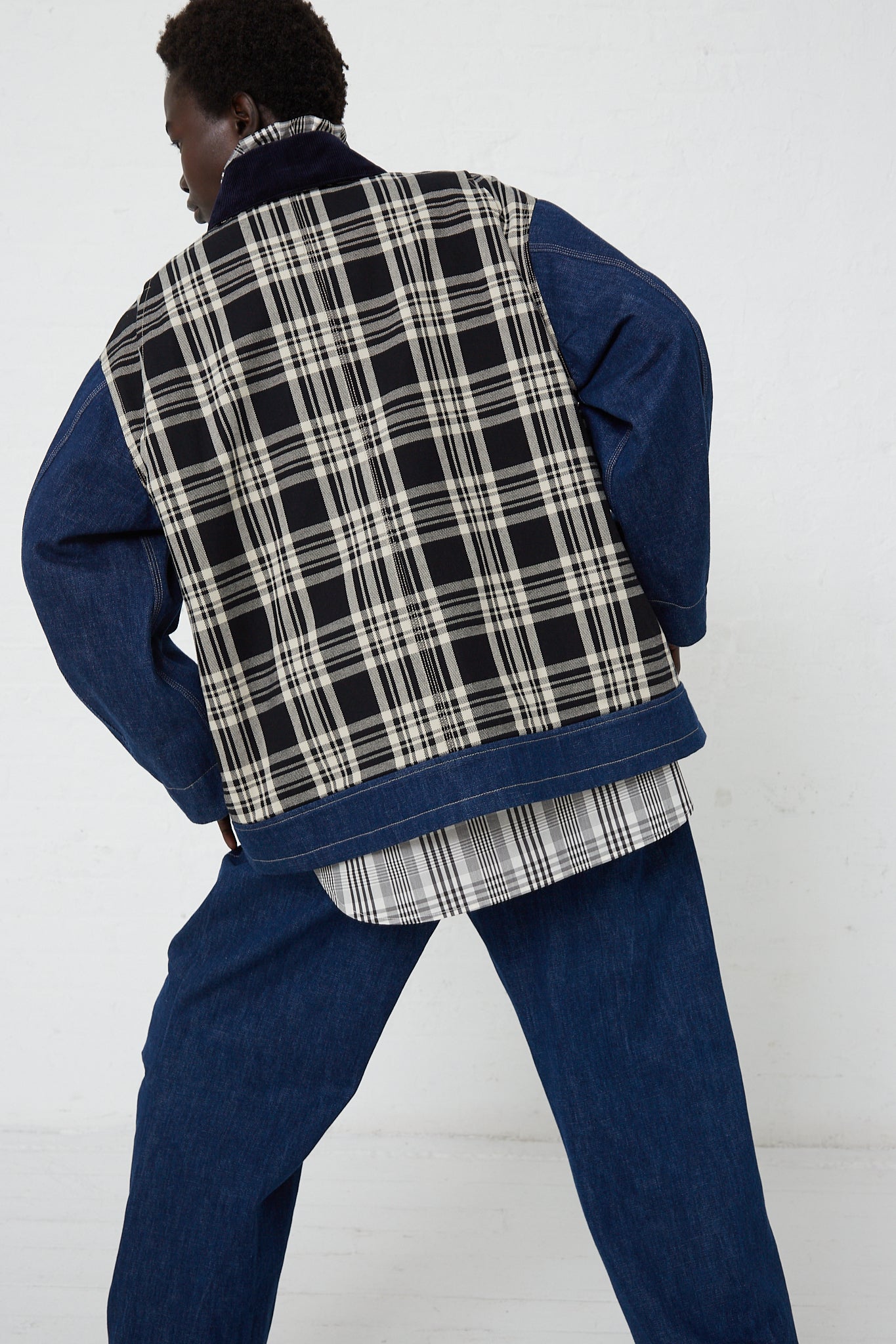 An oversized KasMaria Japanese Denim Chore Jacket in Plaid worn by a model. Back view and full length.