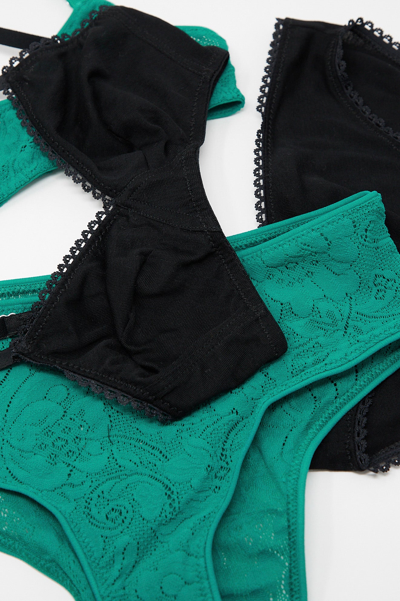 A set of black and green Araks Imogen Hipster in Emerald French lace lingerie.