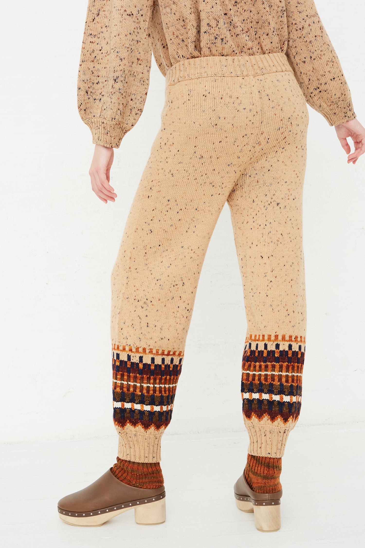 The back view of a woman wearing Misha & Puff's Fair Isle Warm-Up Pant in Seed Confetti jogger pants.