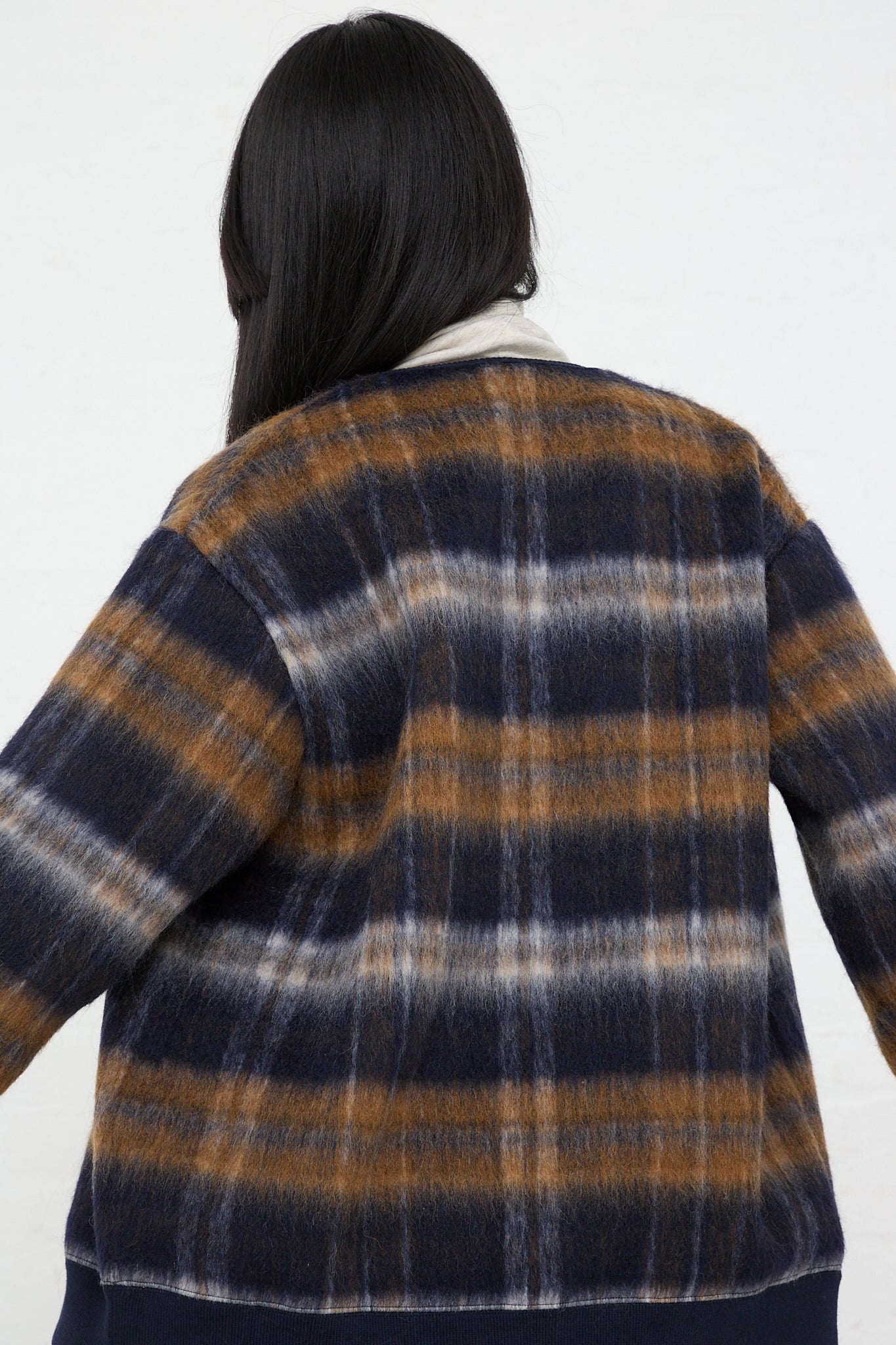 The back view of a woman wearing an Ichi Knit Cardigan in Navy.