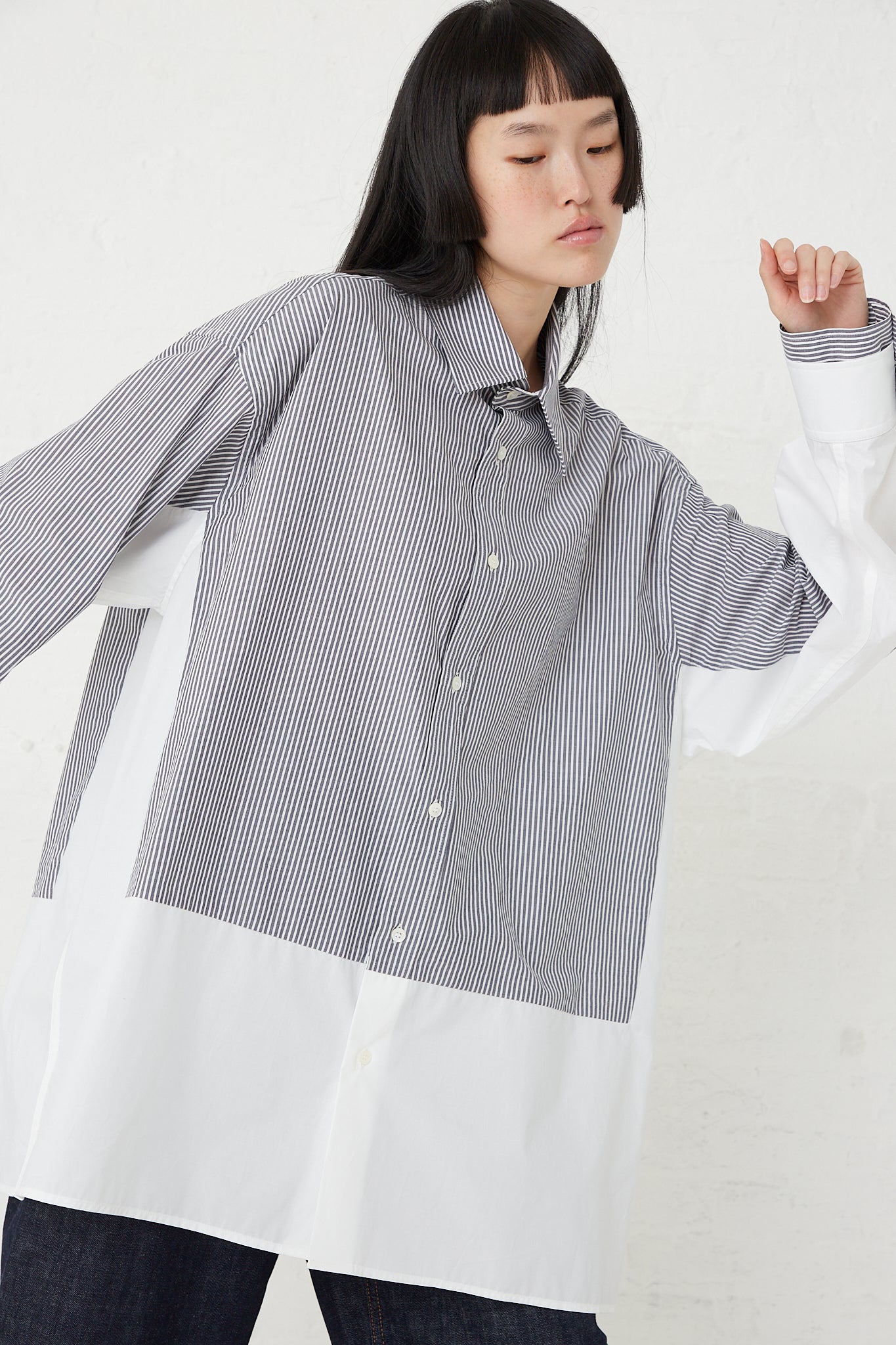 The model is wearing an MM6 Cotton Long Sleeved Shirt in Dark Grey and White.