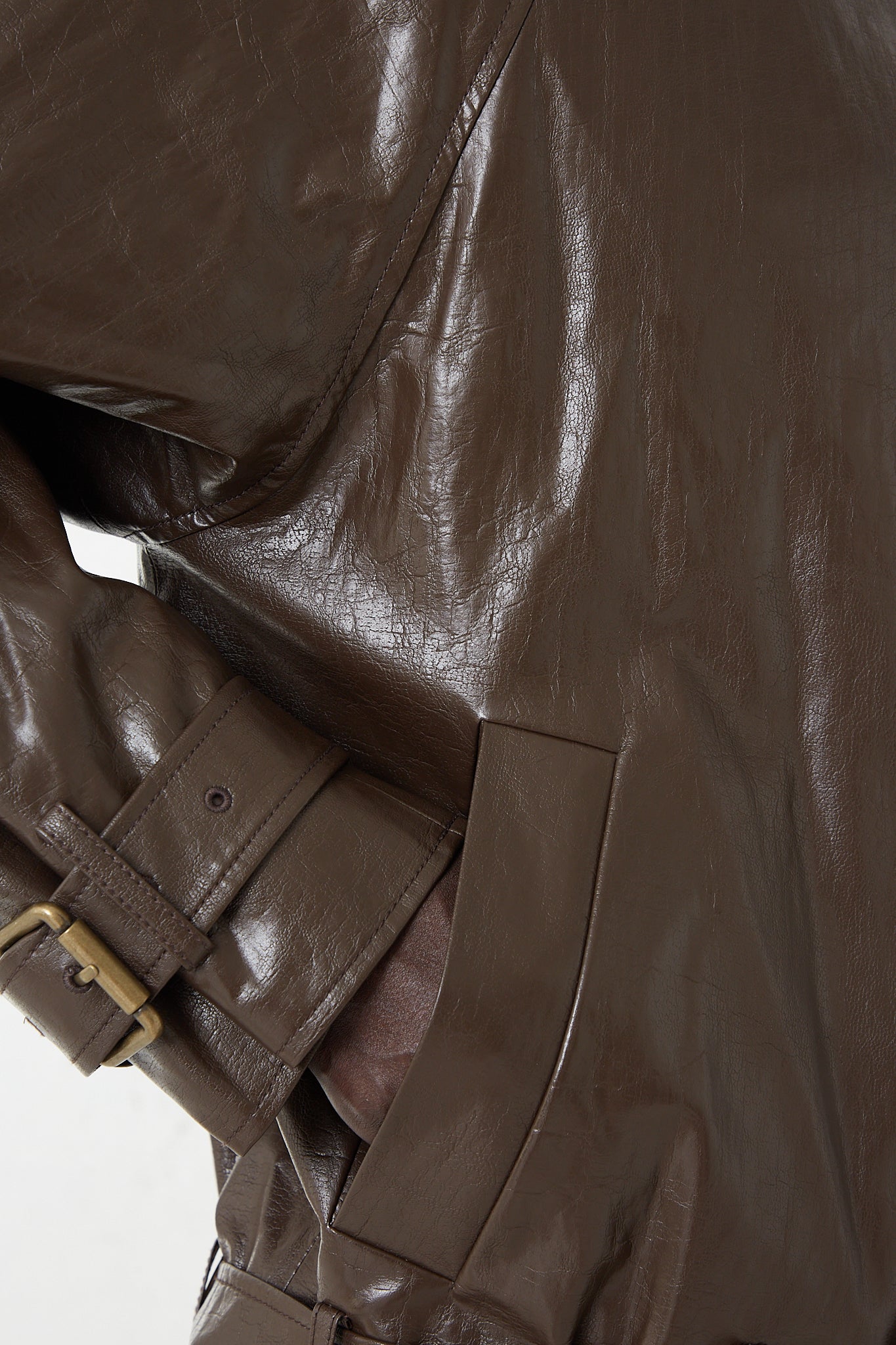 A woman is wearing a Rejina Pyo Faux Leather Juno Jacket in Dark Brown. Up close pocket view.