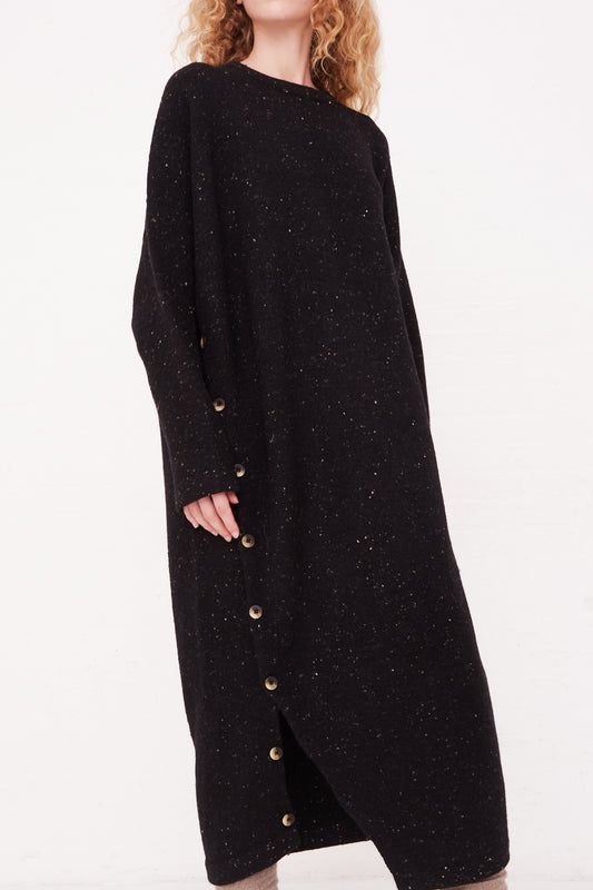 The model is wearing a Button Dress in Black Tweed by Lauren Manoogian.