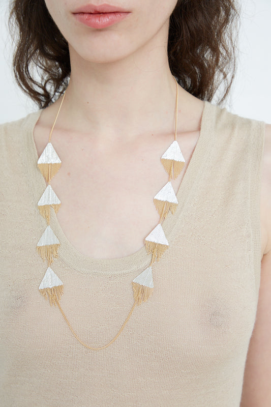 A Hannah Keefe Triangle Necklace in Brass Chain and Silver Solder.