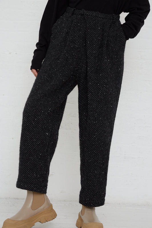 The model is wearing the Snow Nep Wool Pant in Black by Ichi Antiquités.